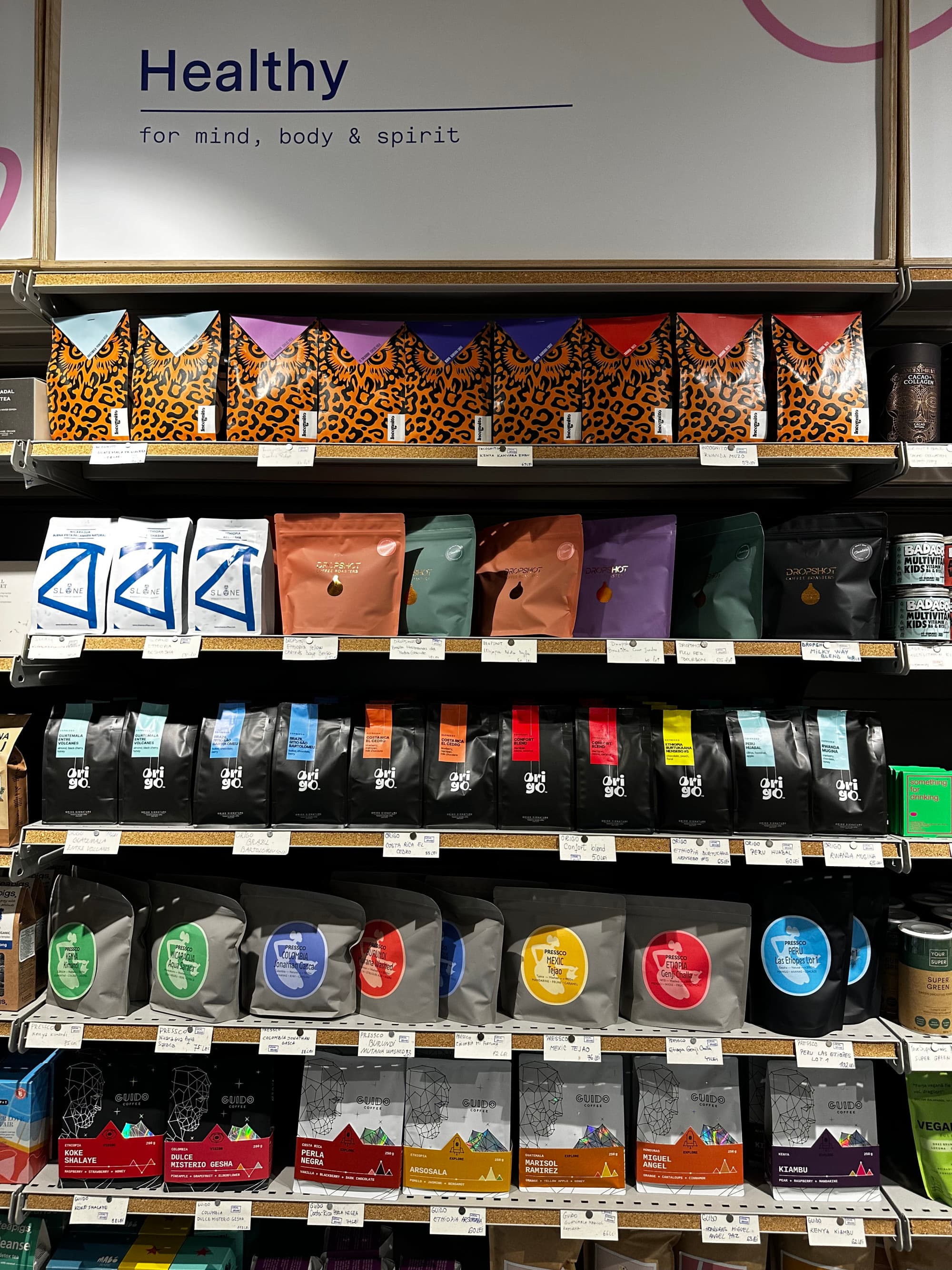 An assortment of various coffee bags in various colors inside of a supermarket.