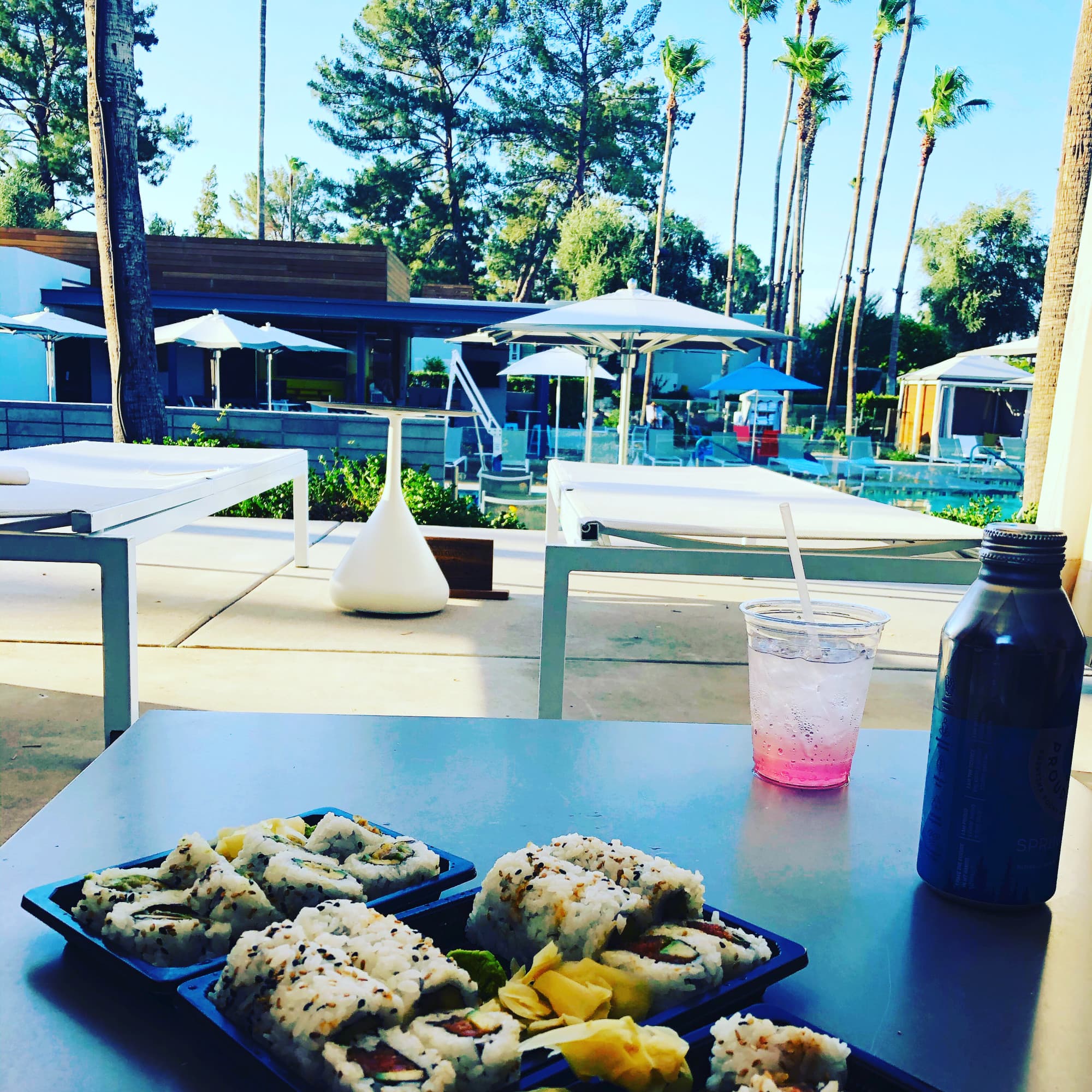 Food on a plate next to an outdoor pool
