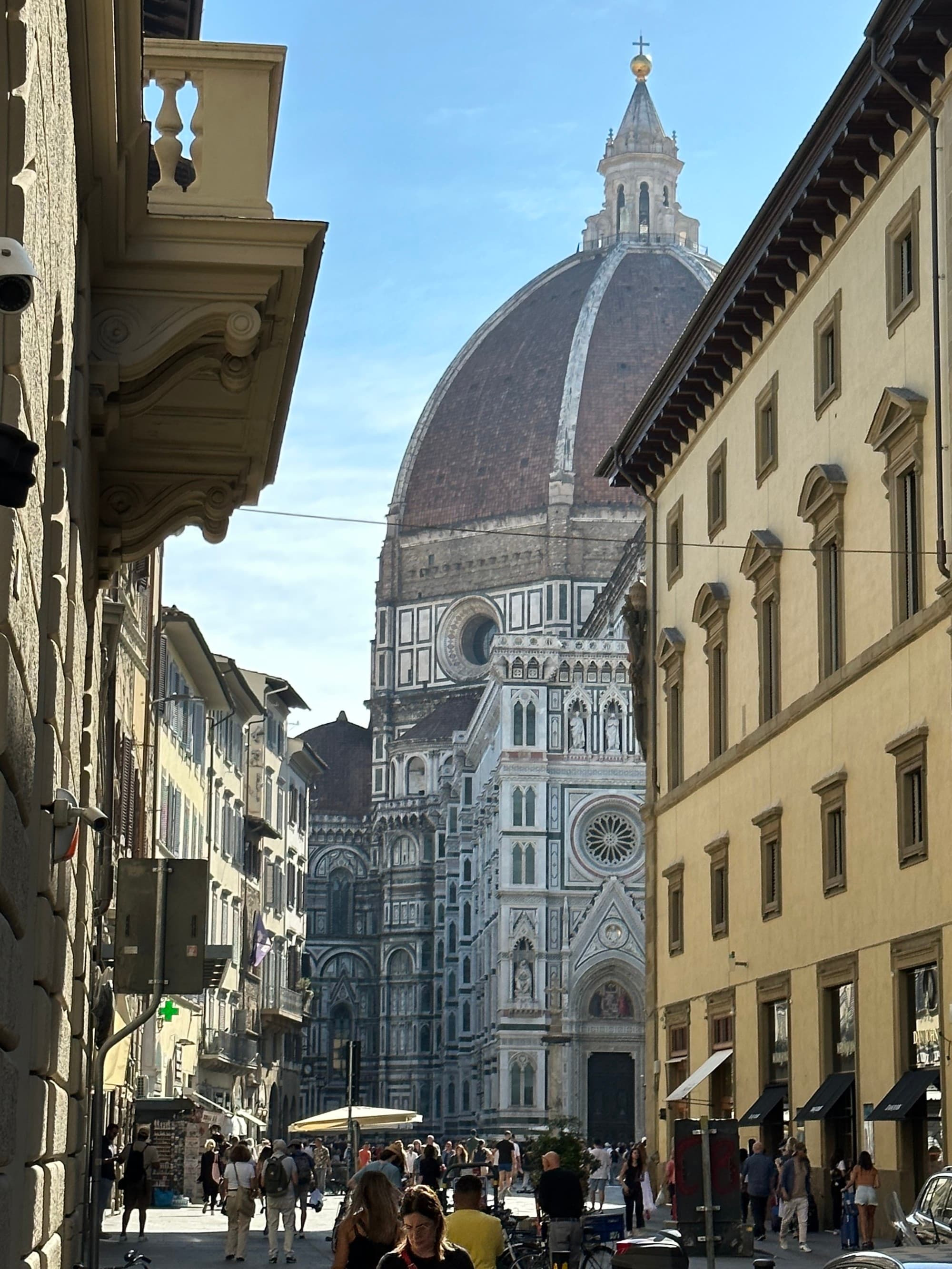 The Duomo in Florence at the end of a city street.