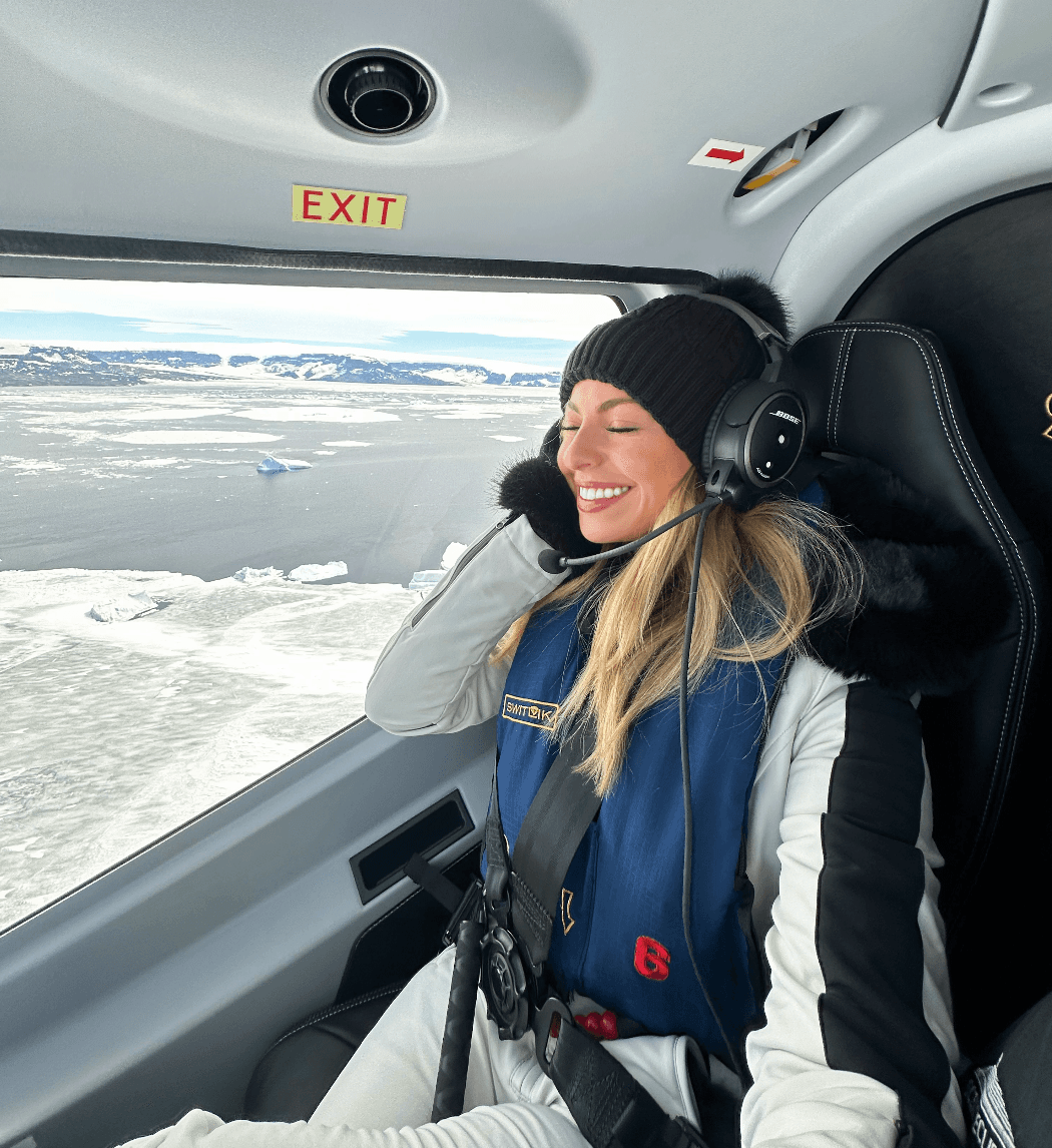 A person posing for a photo in a helicopter