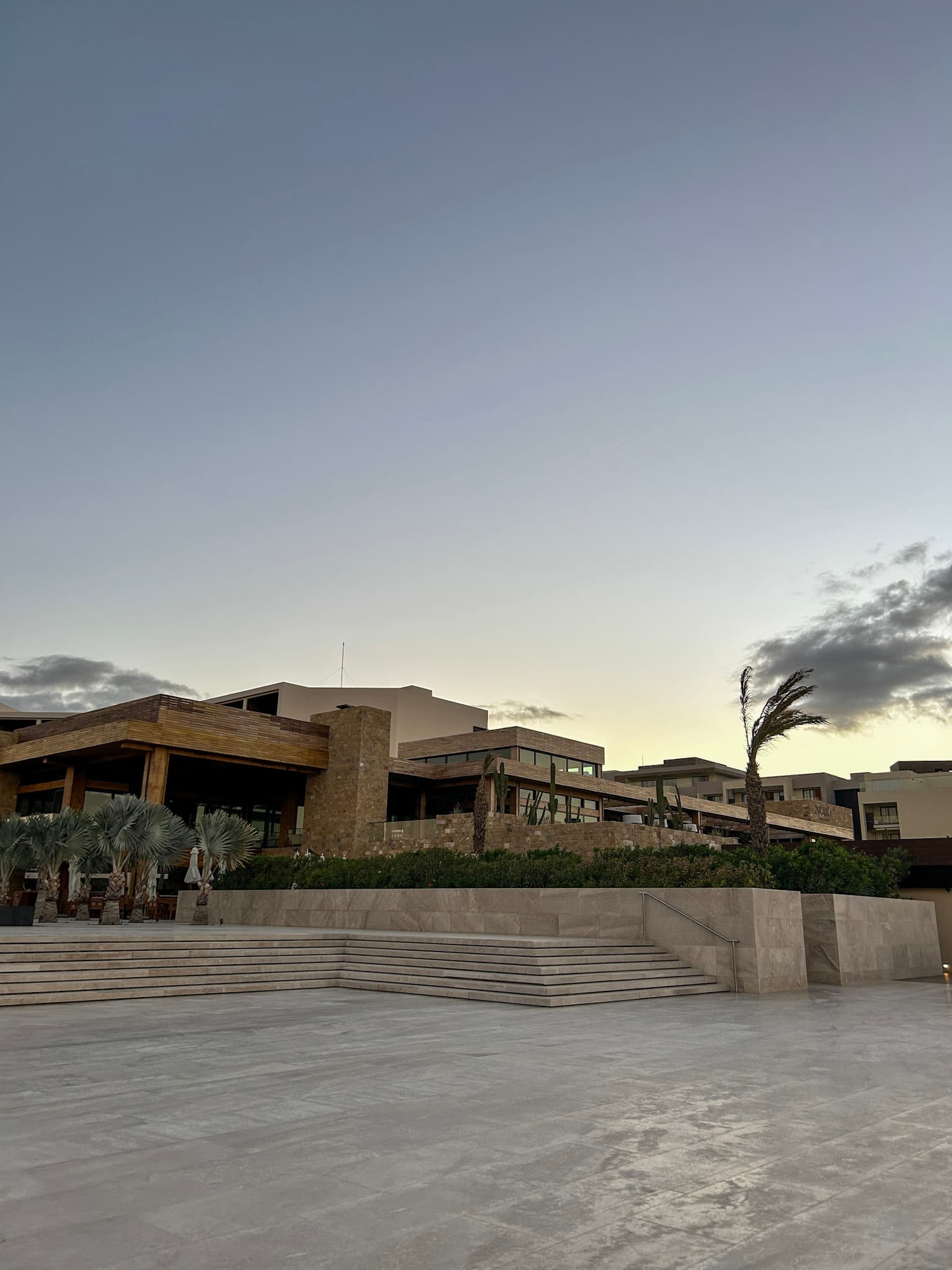 A view of the Nobu hotel exterior with stonework design and trees.