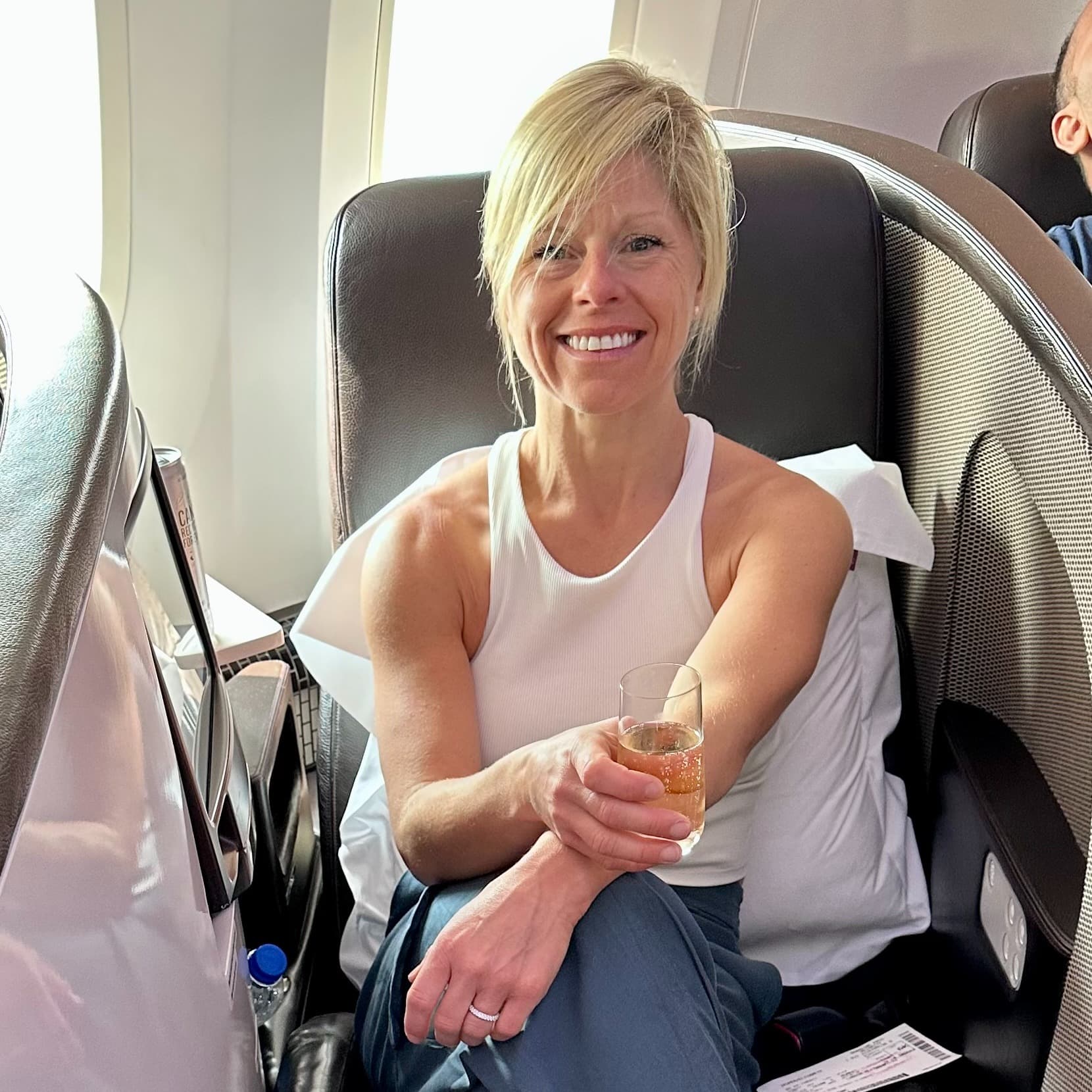 a woman sits cross-legged on a cozy chair