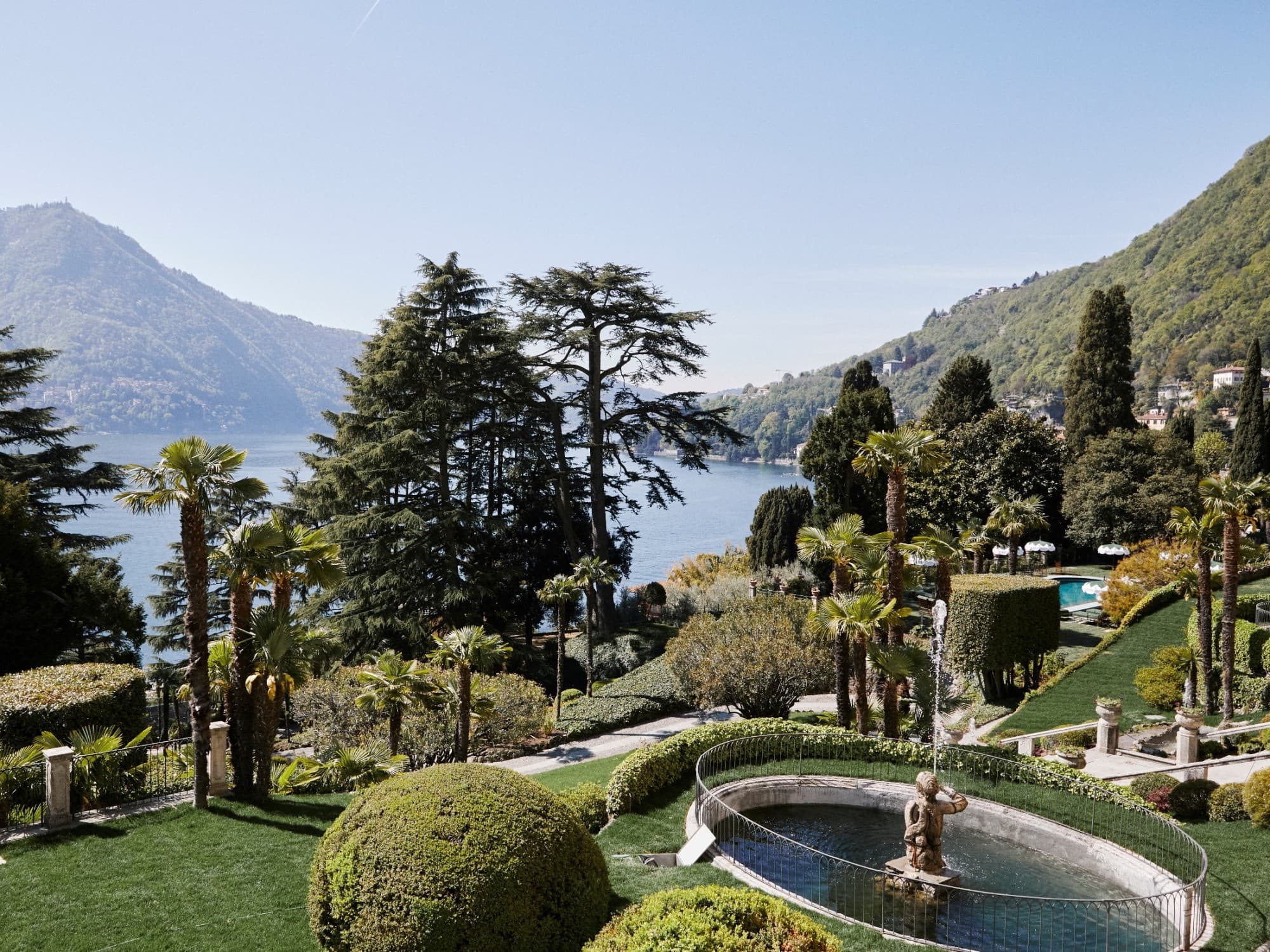 a lush, sprawling garden overlooking a lake