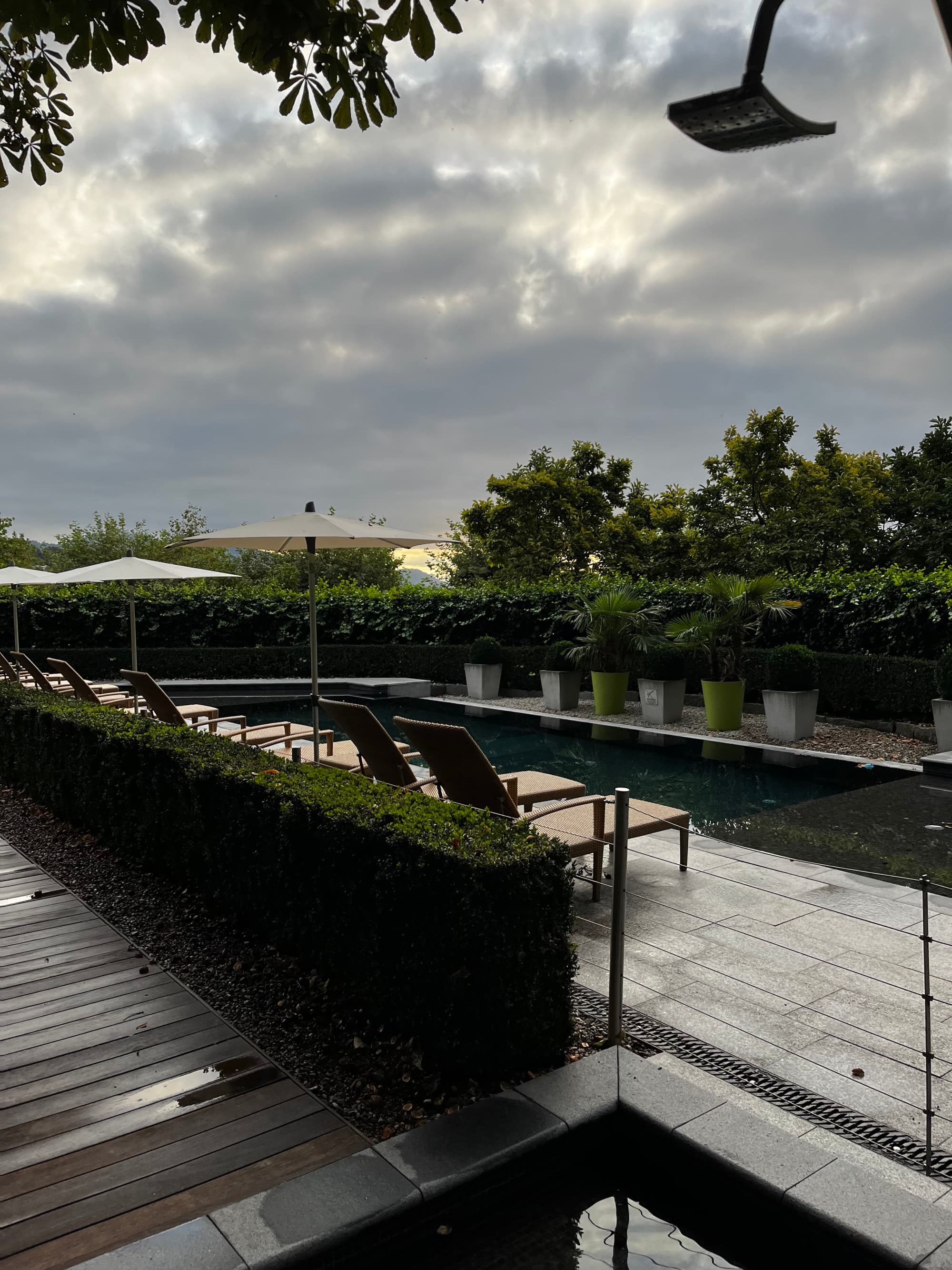 Sky and park view with a pool in the courtyard with loungers