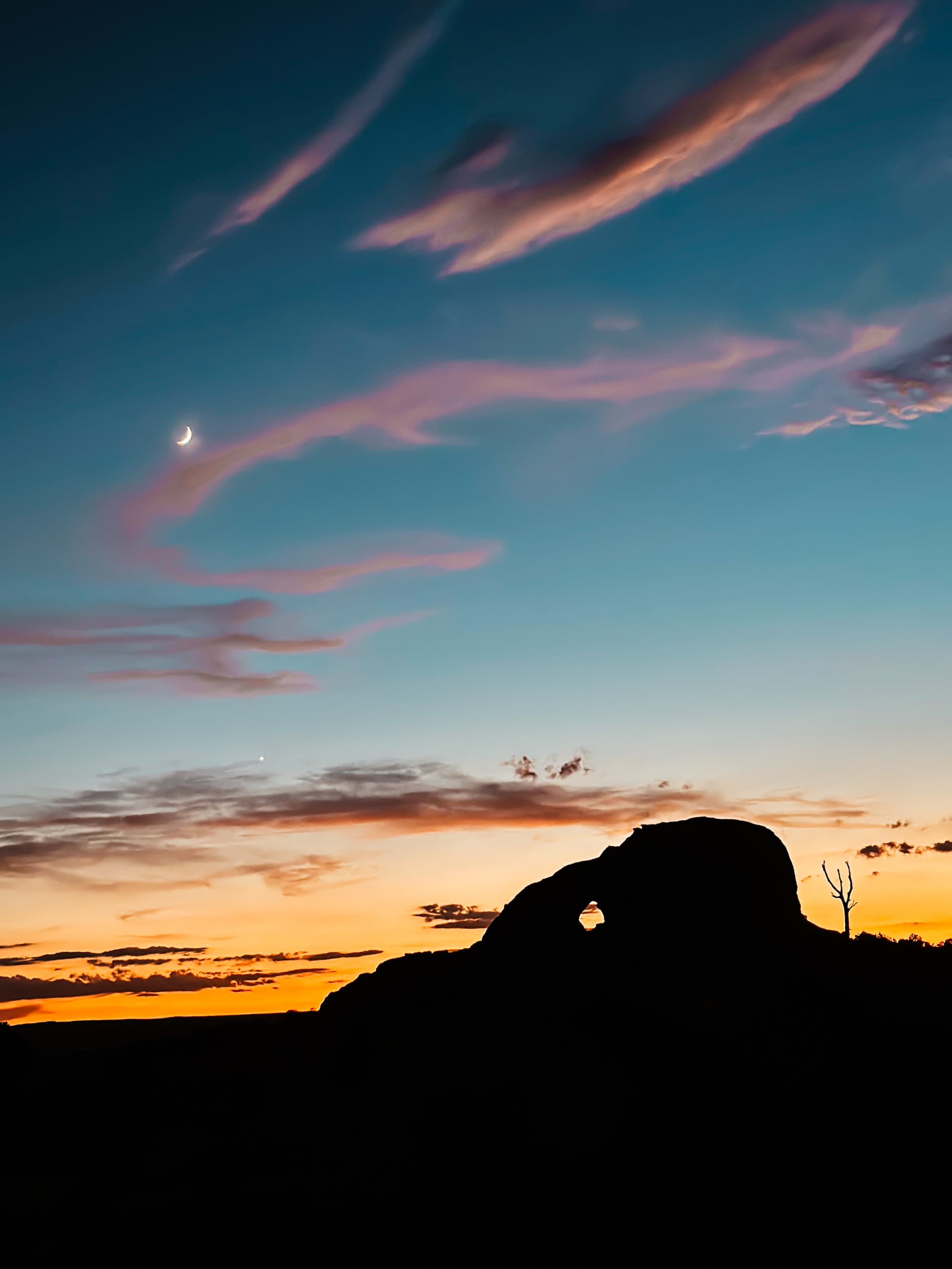 Sunset and sky view with magical clouds spread about of orange and light pink.