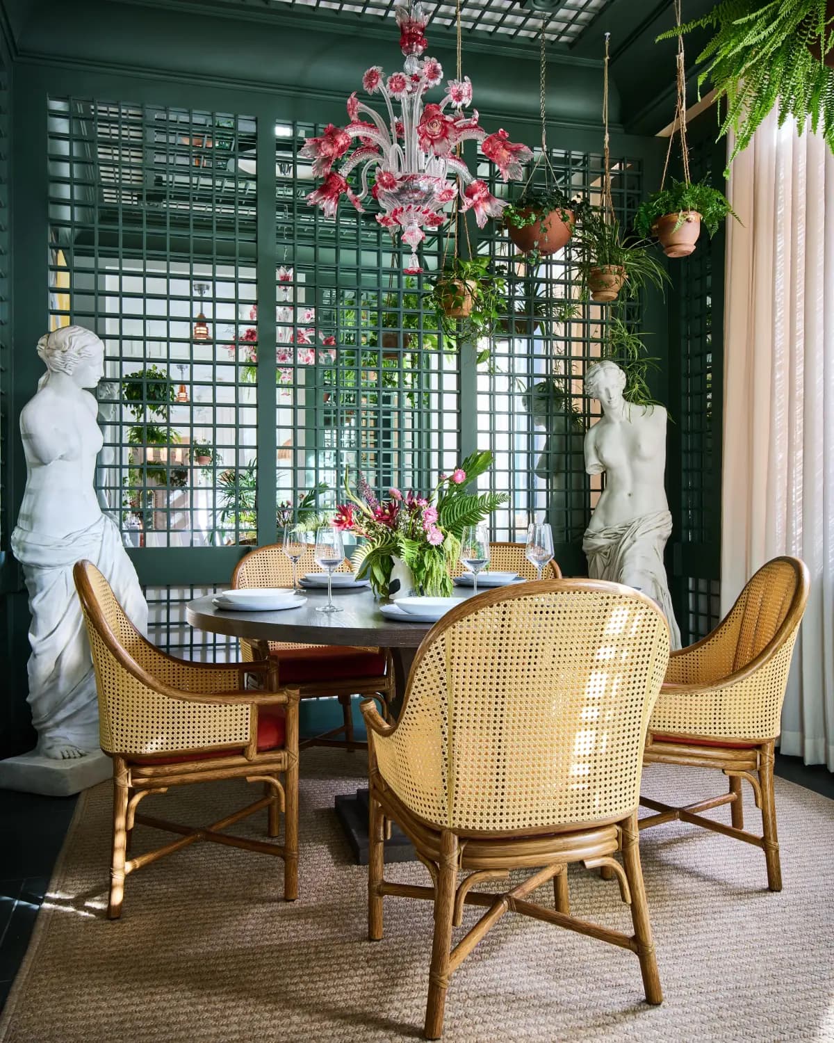 a table in a cozy nook with stone statures of women