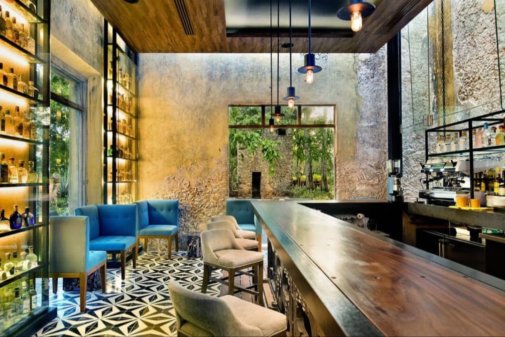 wooden bar near a shelf of tequila bottles