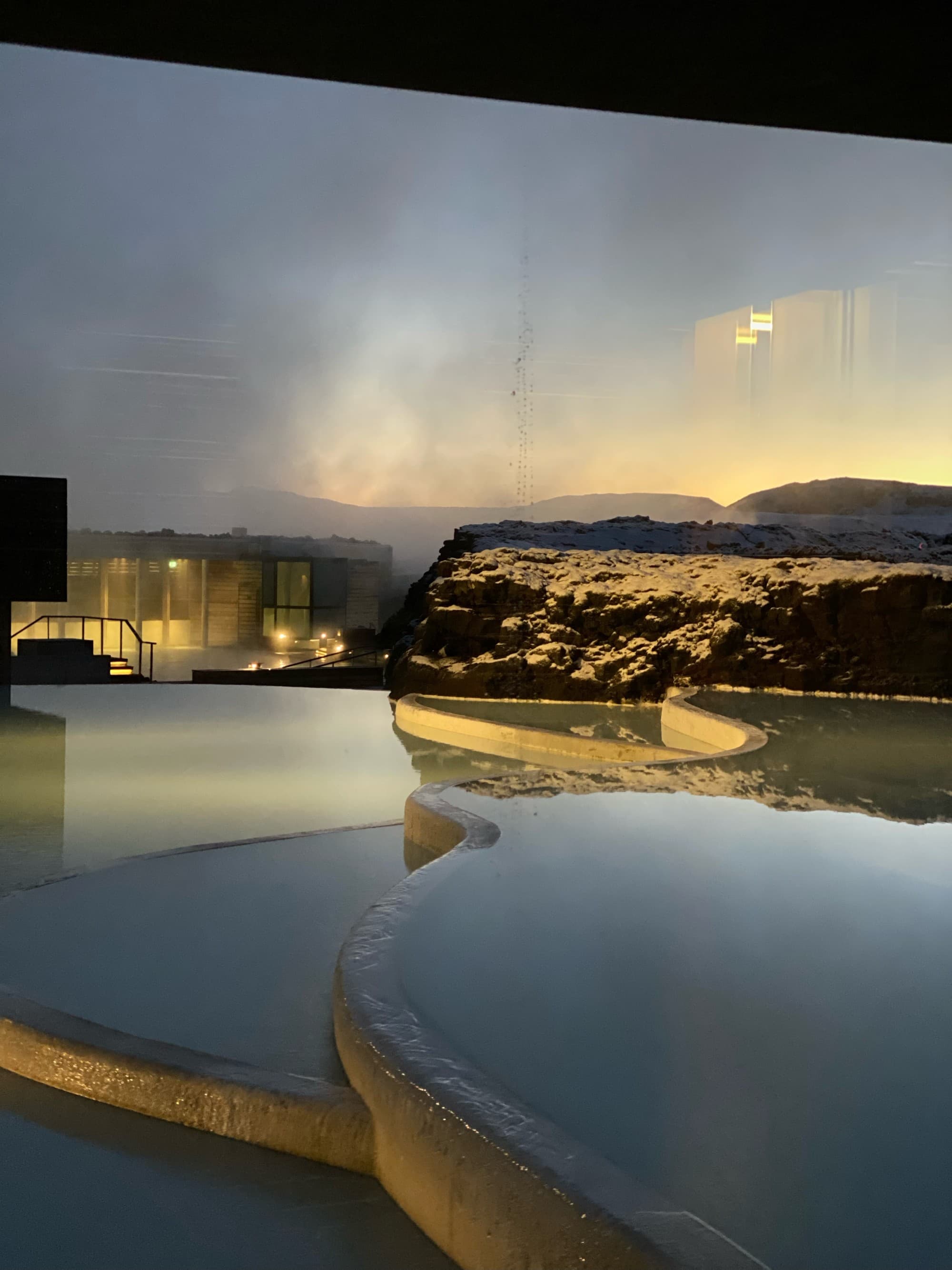 A serene pool in a natural landscape.