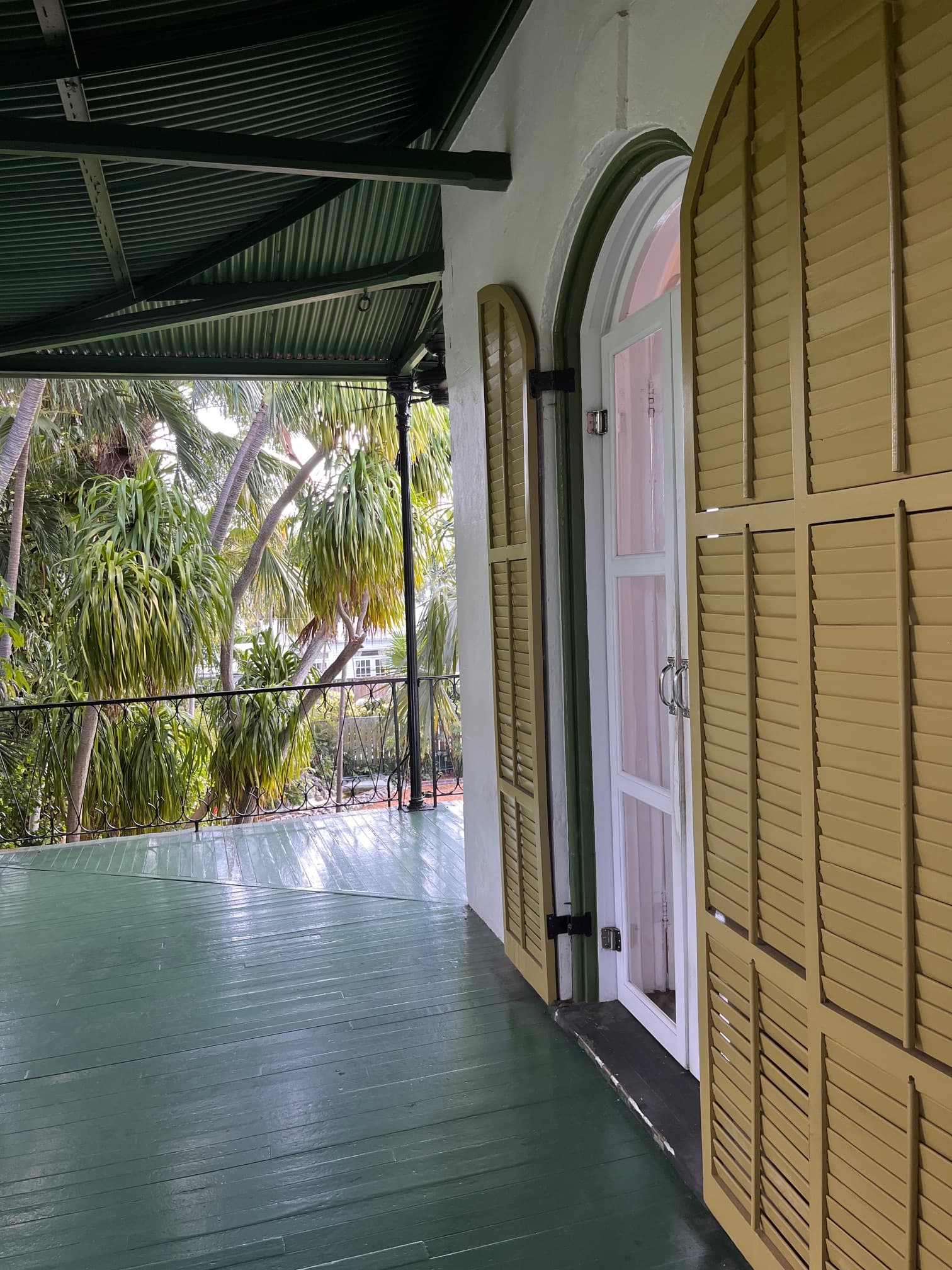 An arched window with brown shutters