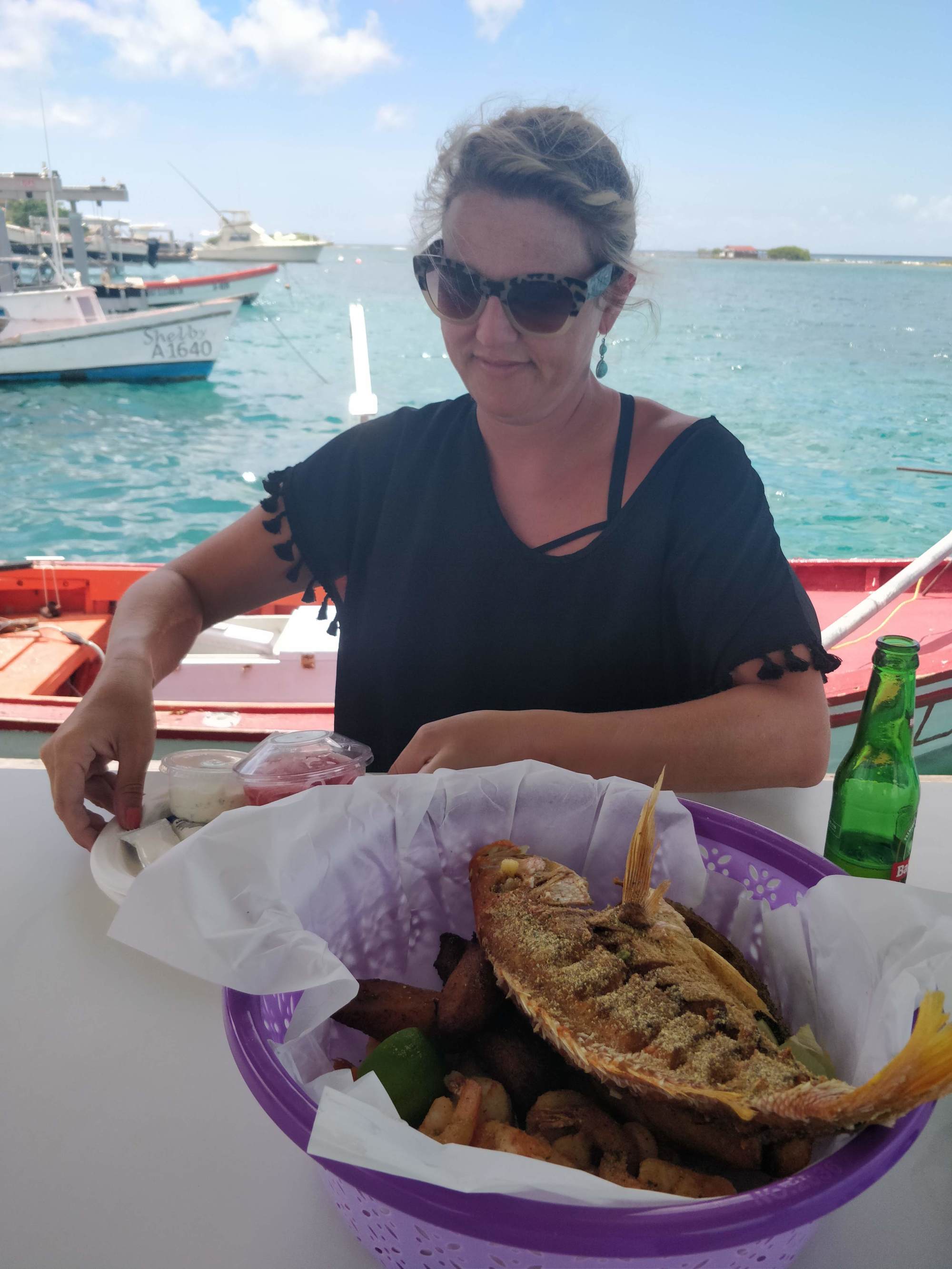 A person eating a plate of food outside