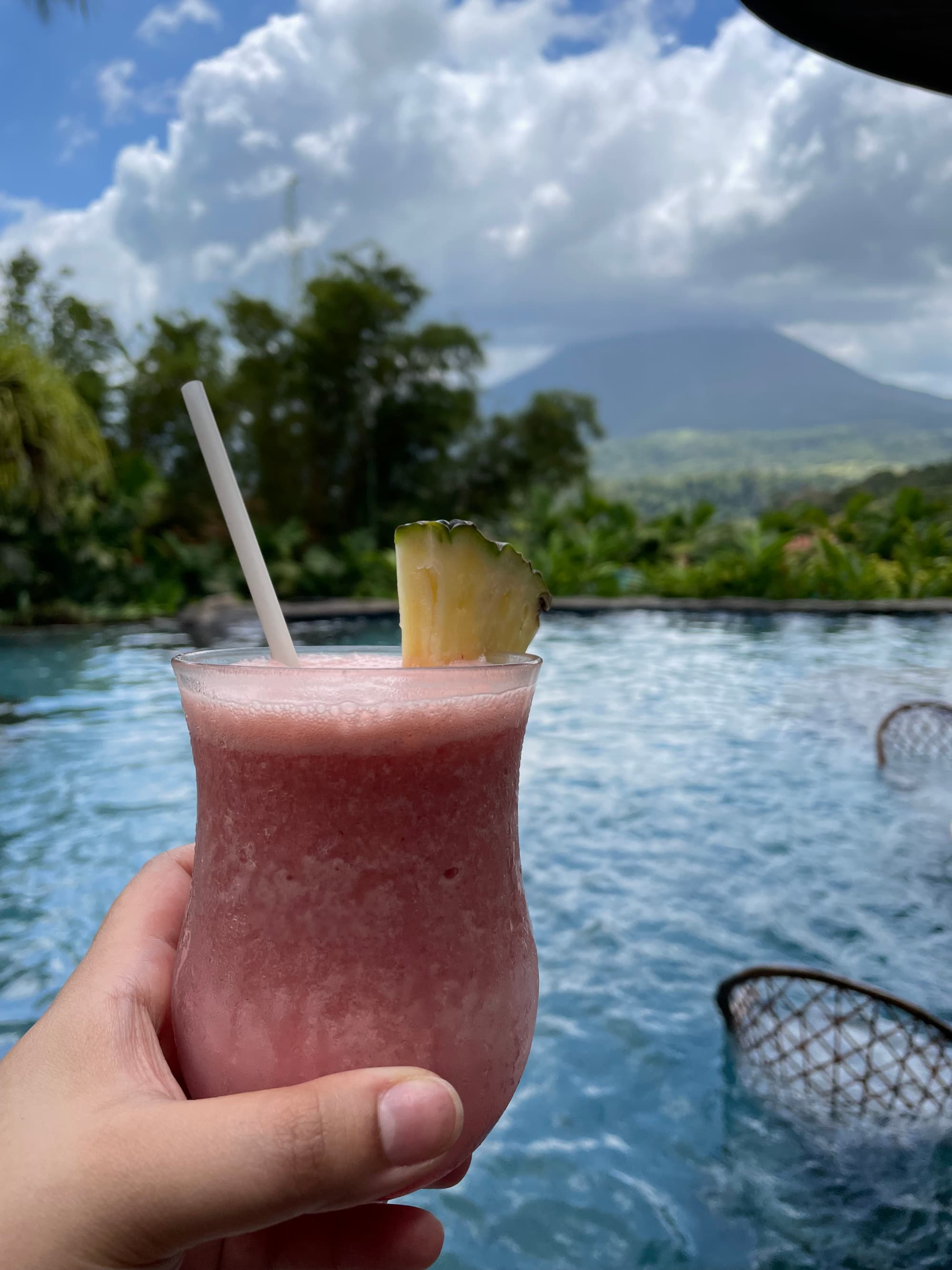 Holding a frozen drink poolside