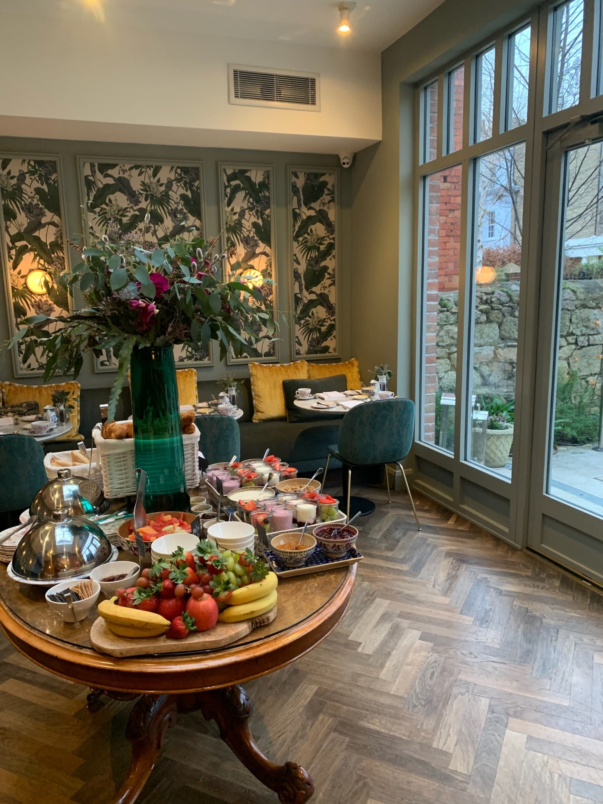 A dining area with a table full of breakfast food