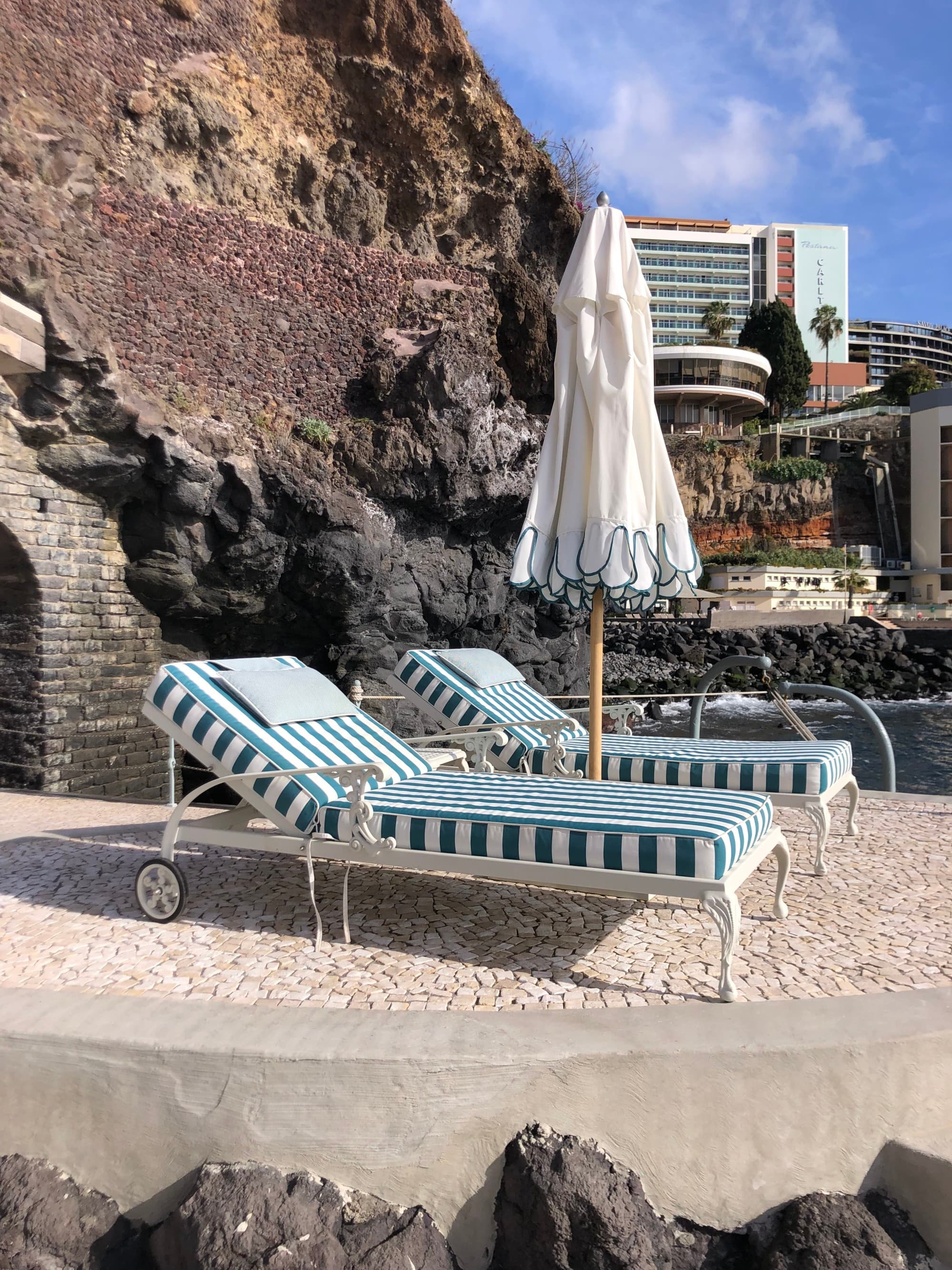 Reids Seaside Sun Loungers with the mountain side in the distance and clear skies