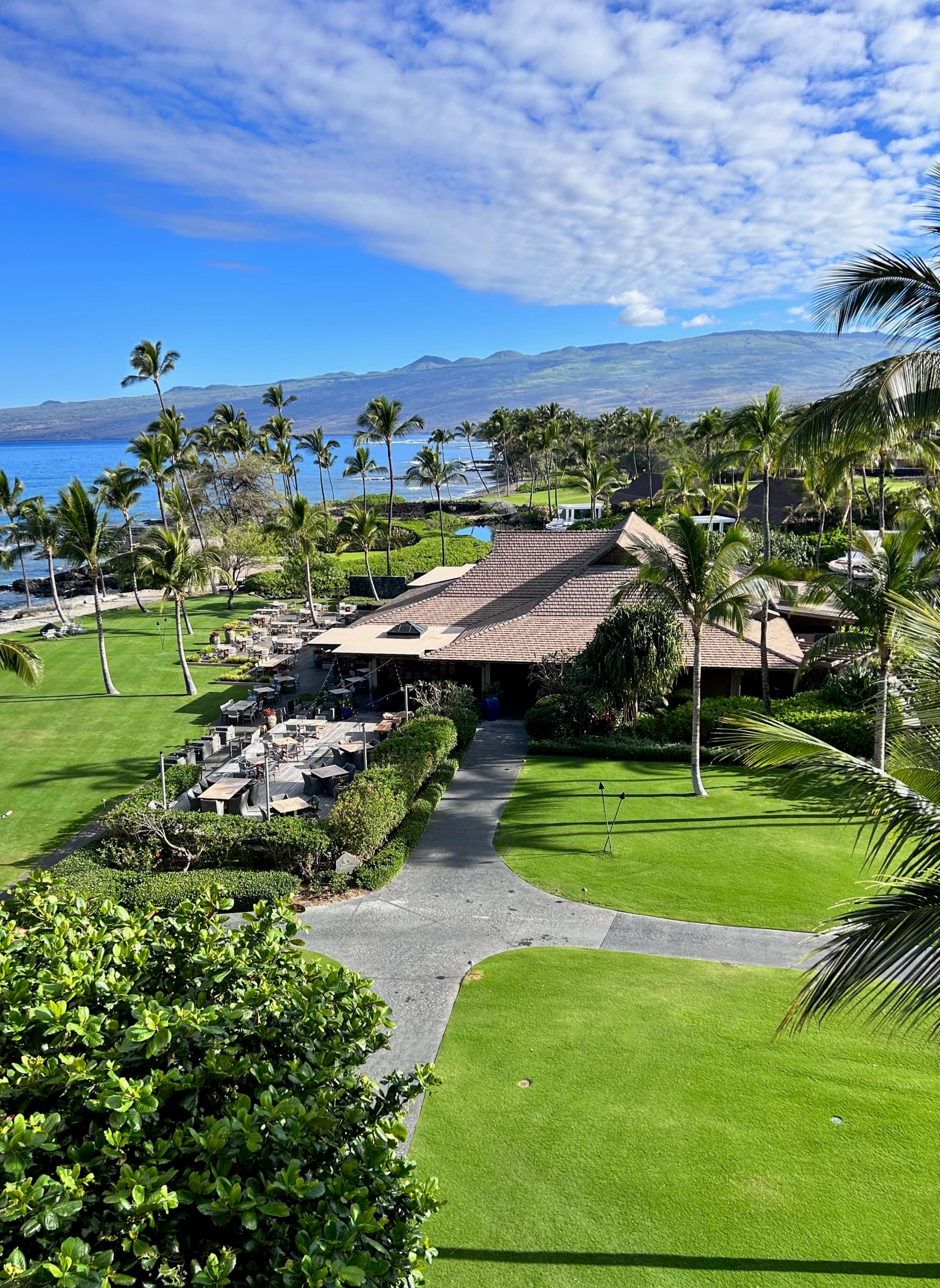 Aerial view of a group of green lawns with a building in the middle during the daytime