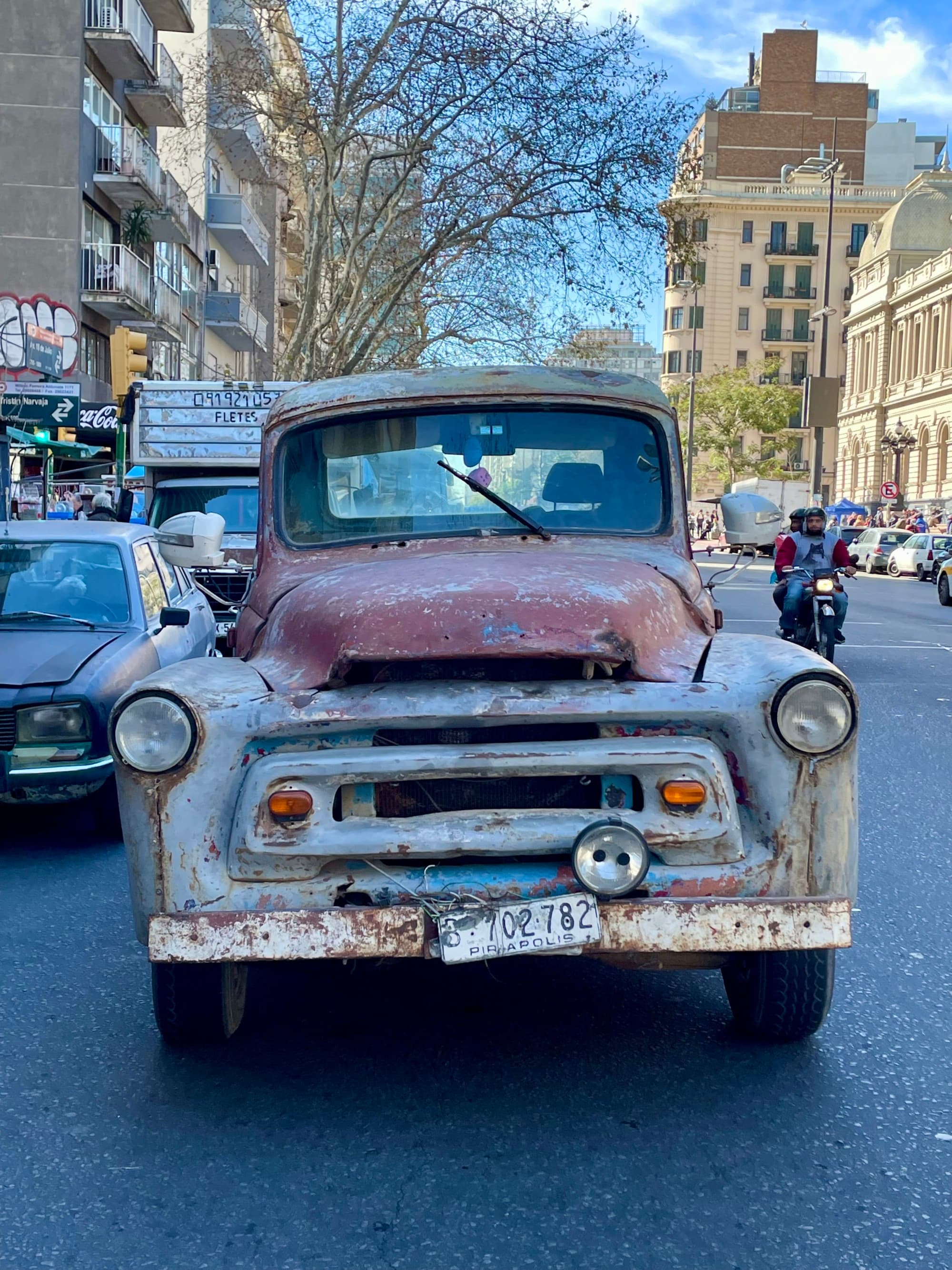 A vintage truck outside in a city.