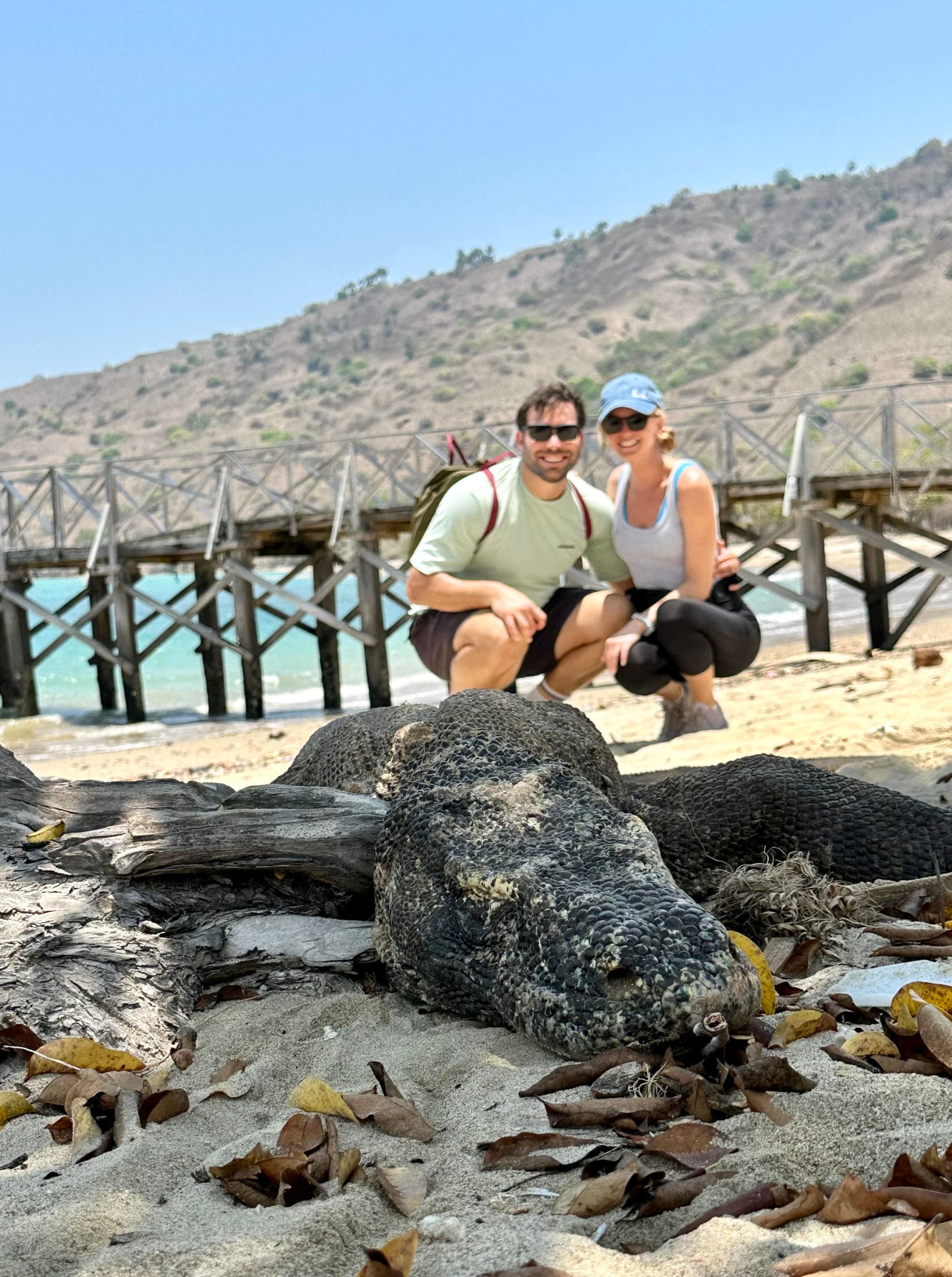 A couple posing on a beach during the daytime