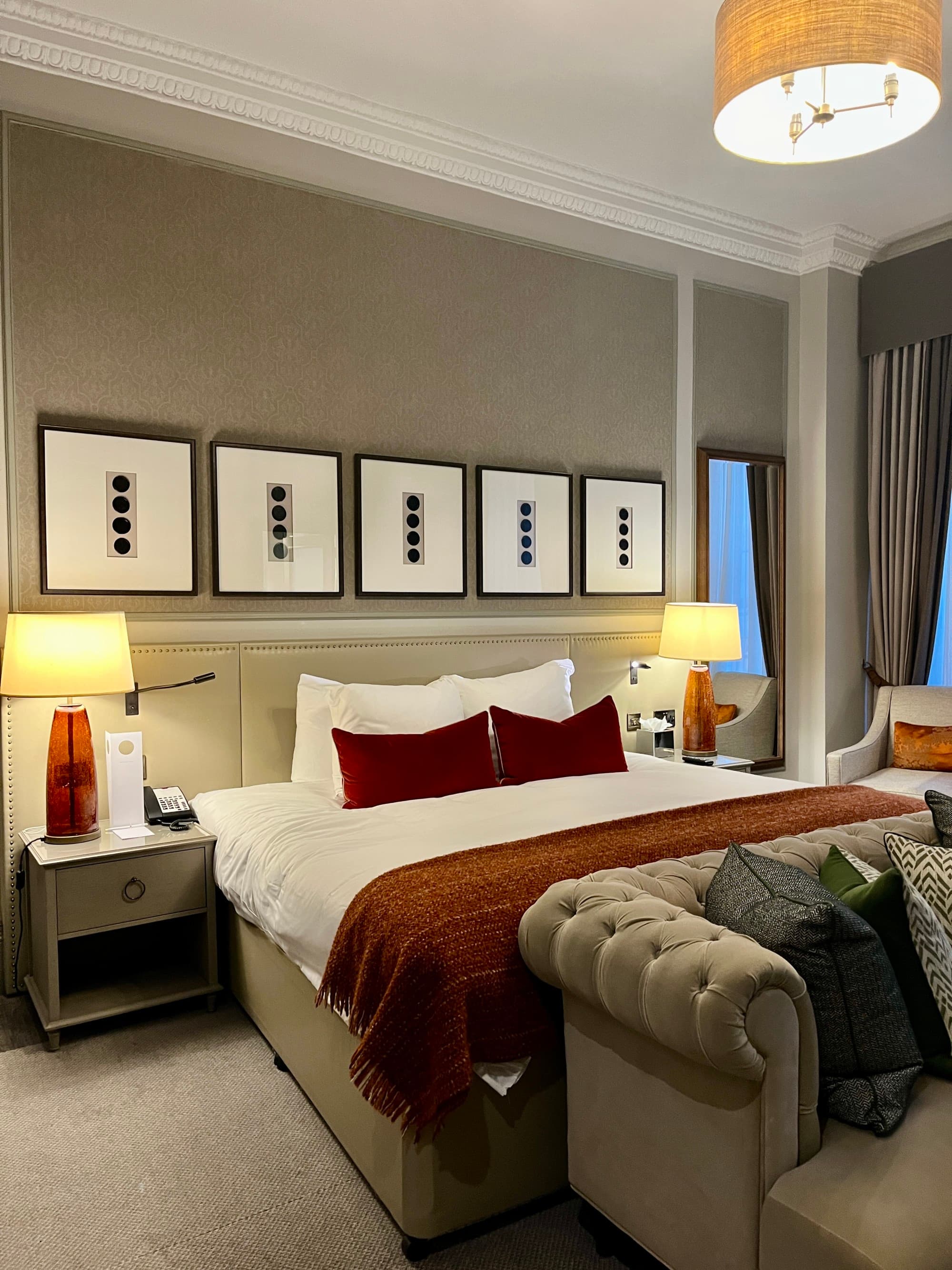 A bed with white sheets in the middle of a hotel room