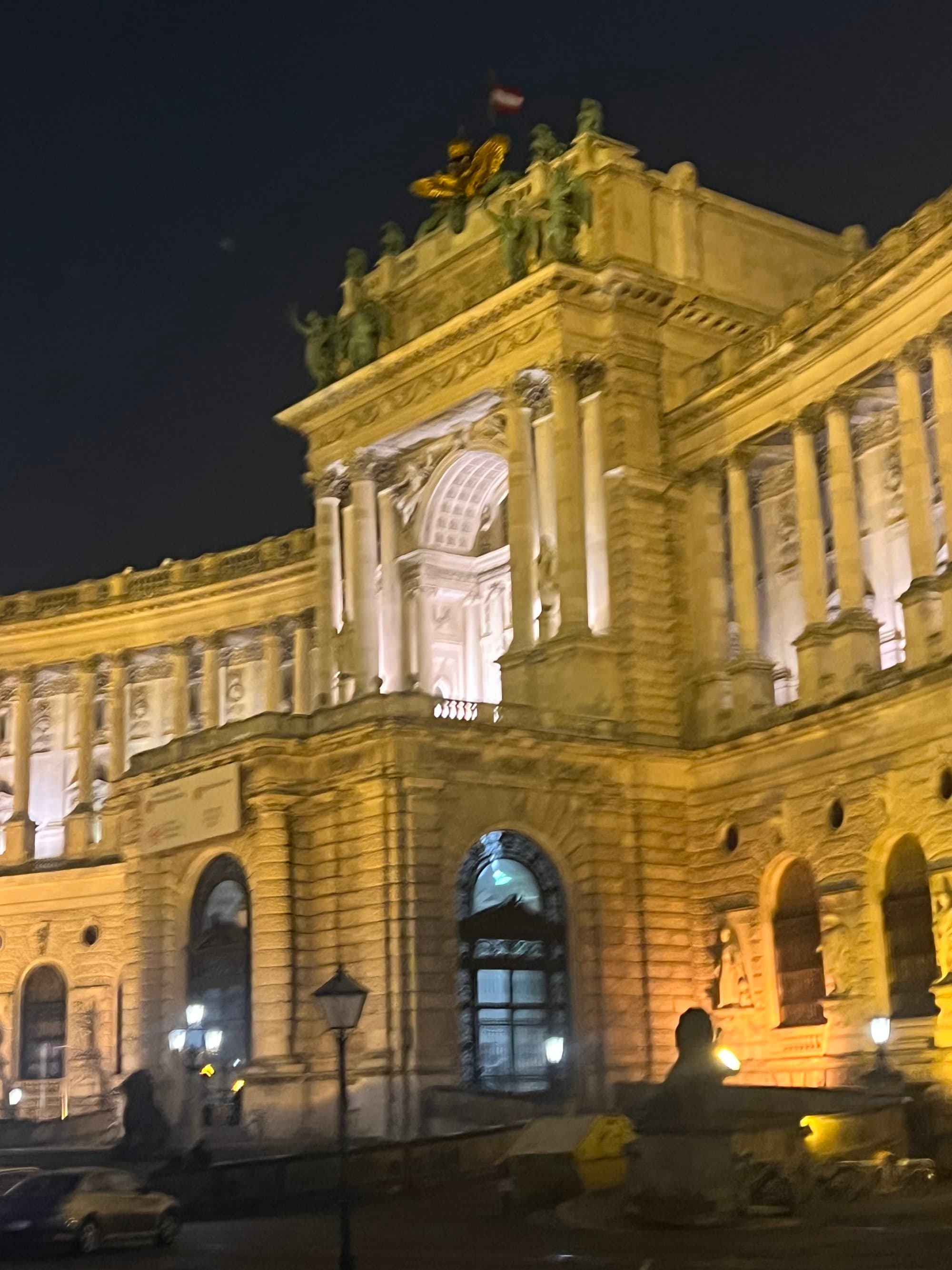 Hofburg Palace at night, a lit-up stately yellow building