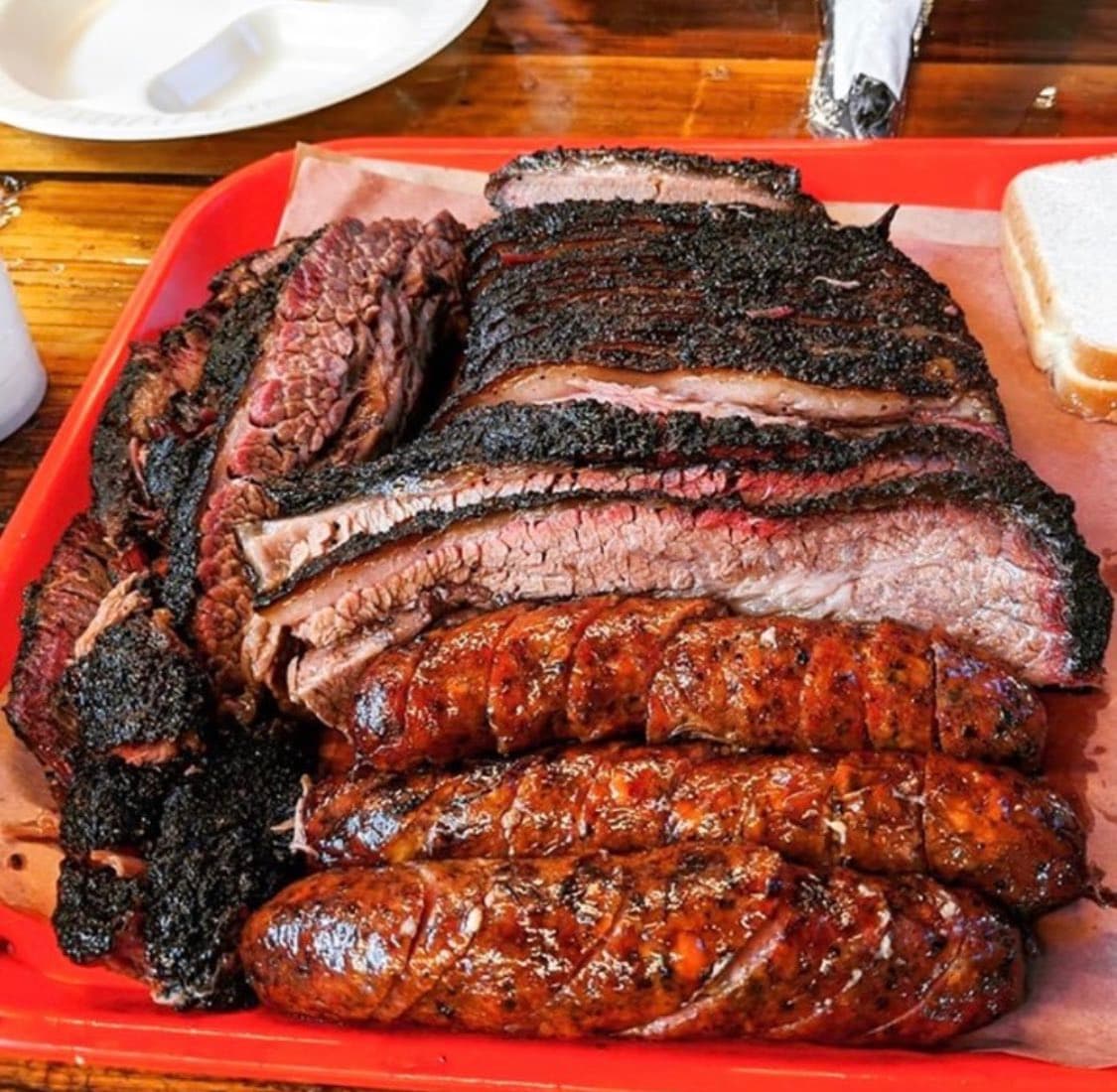 Barbecued meats on a red plate
