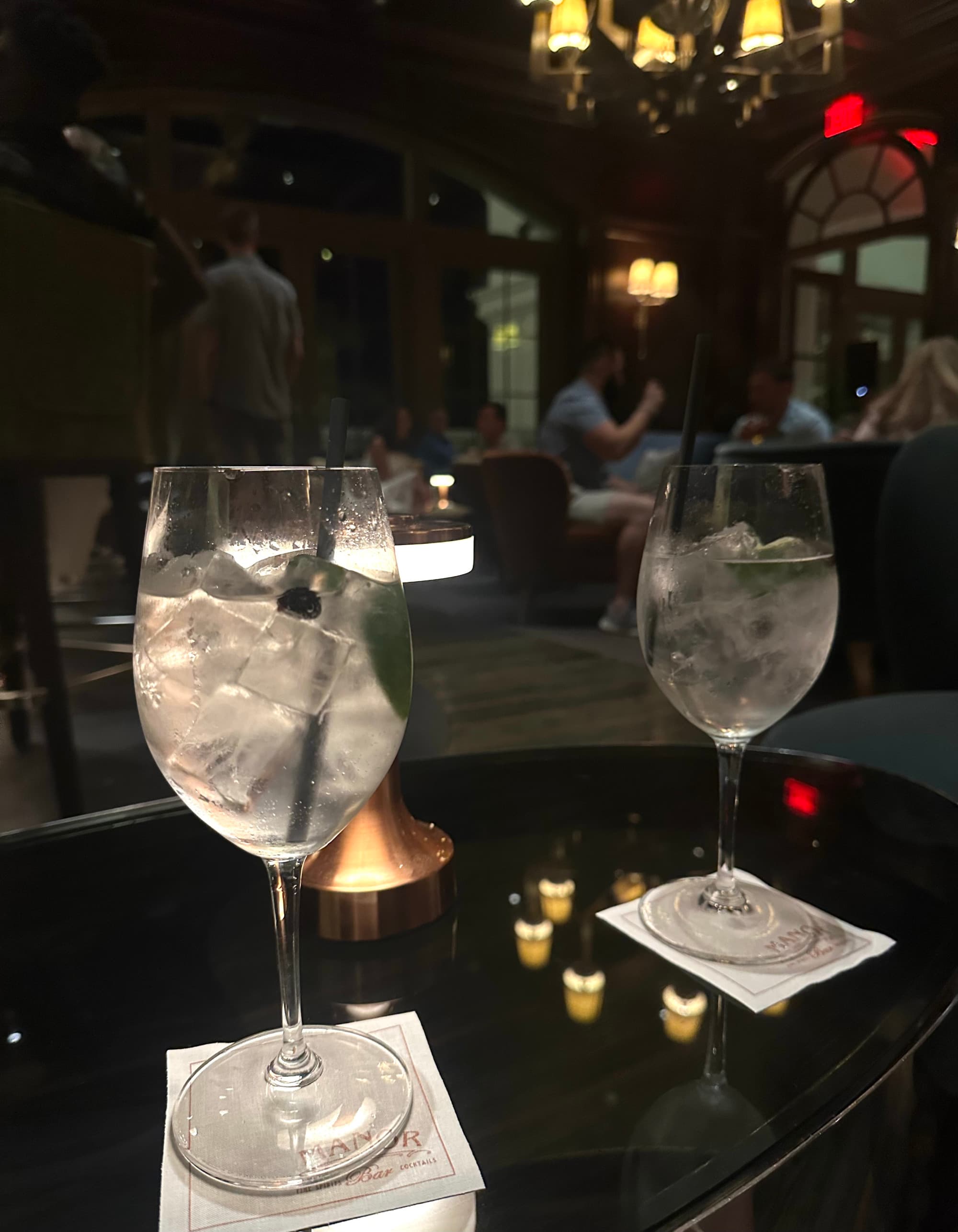 Cocktail hour at the hotel bar, with two glasses of refreshing, clear-colored beverages.