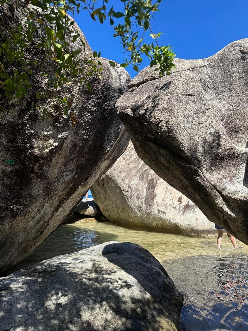 Two large rocks leaning against each other on the beach