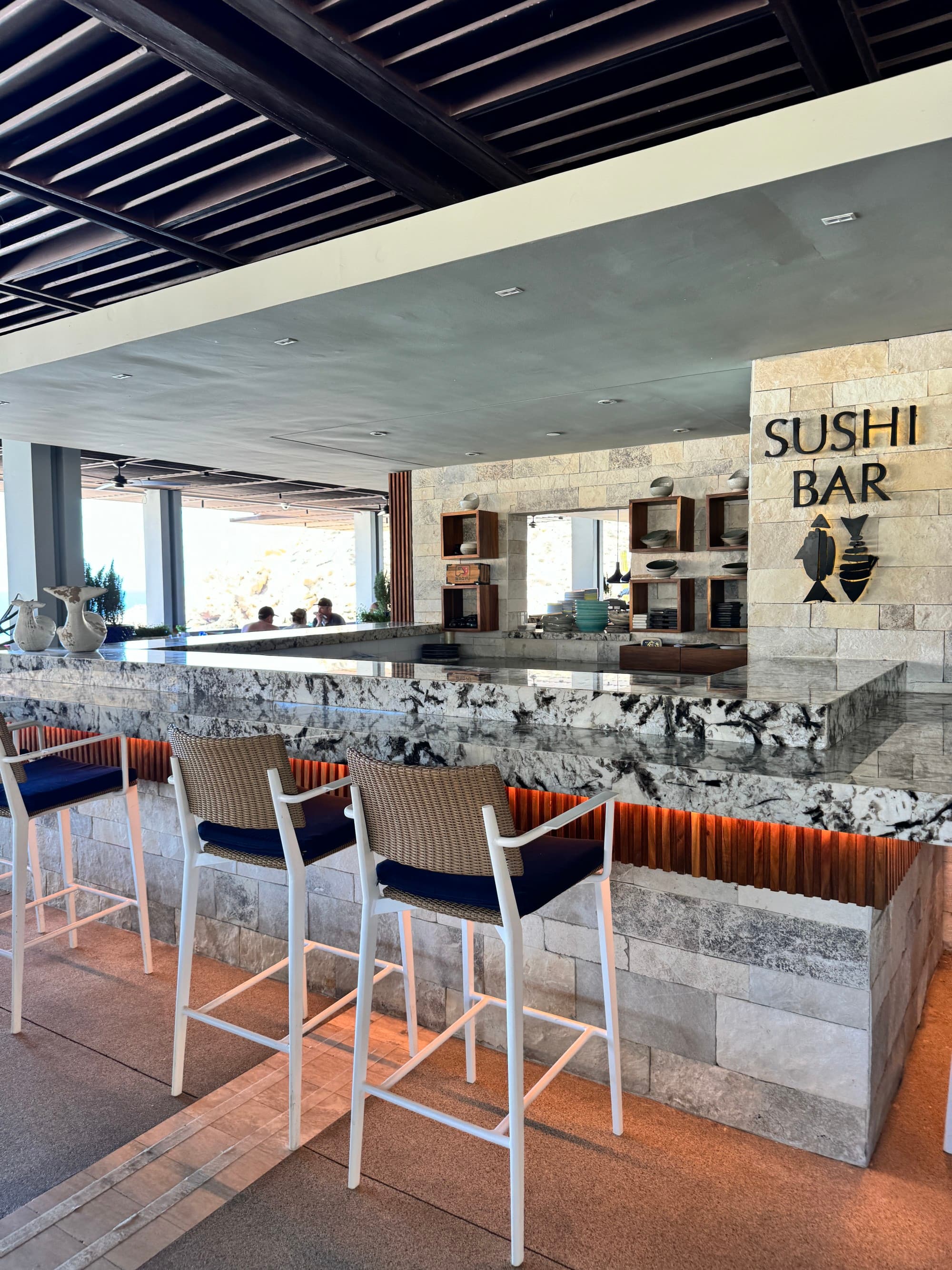 A look at the hotel's sushi bar restaurant, with stone tiles for the bar, and high bar chairs.