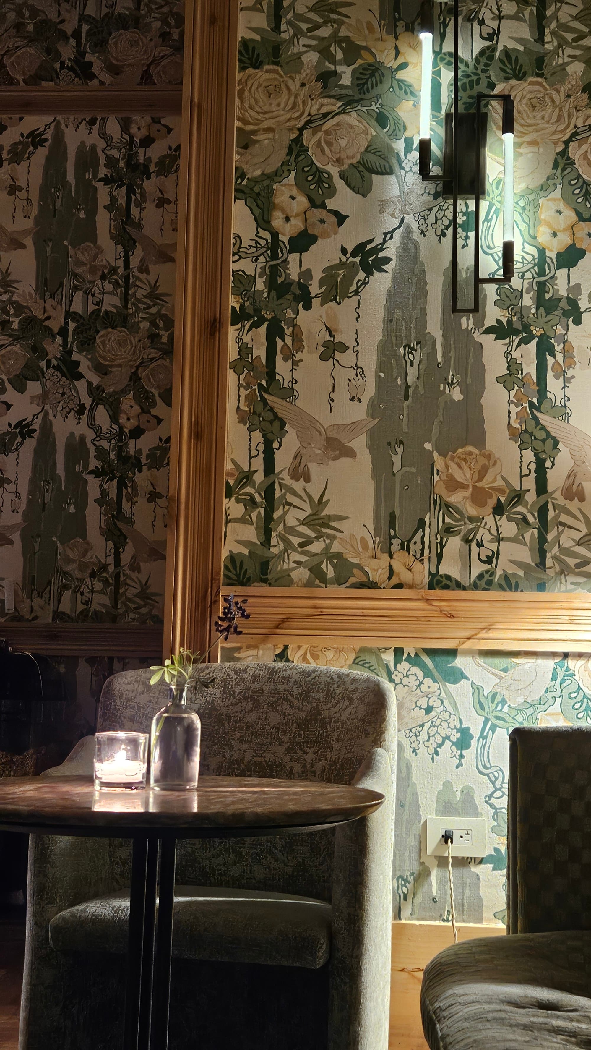 The decor at Goldies sunken bar, with green wallpaper, gray chairs and industrial-style lighting - Nicole Diez