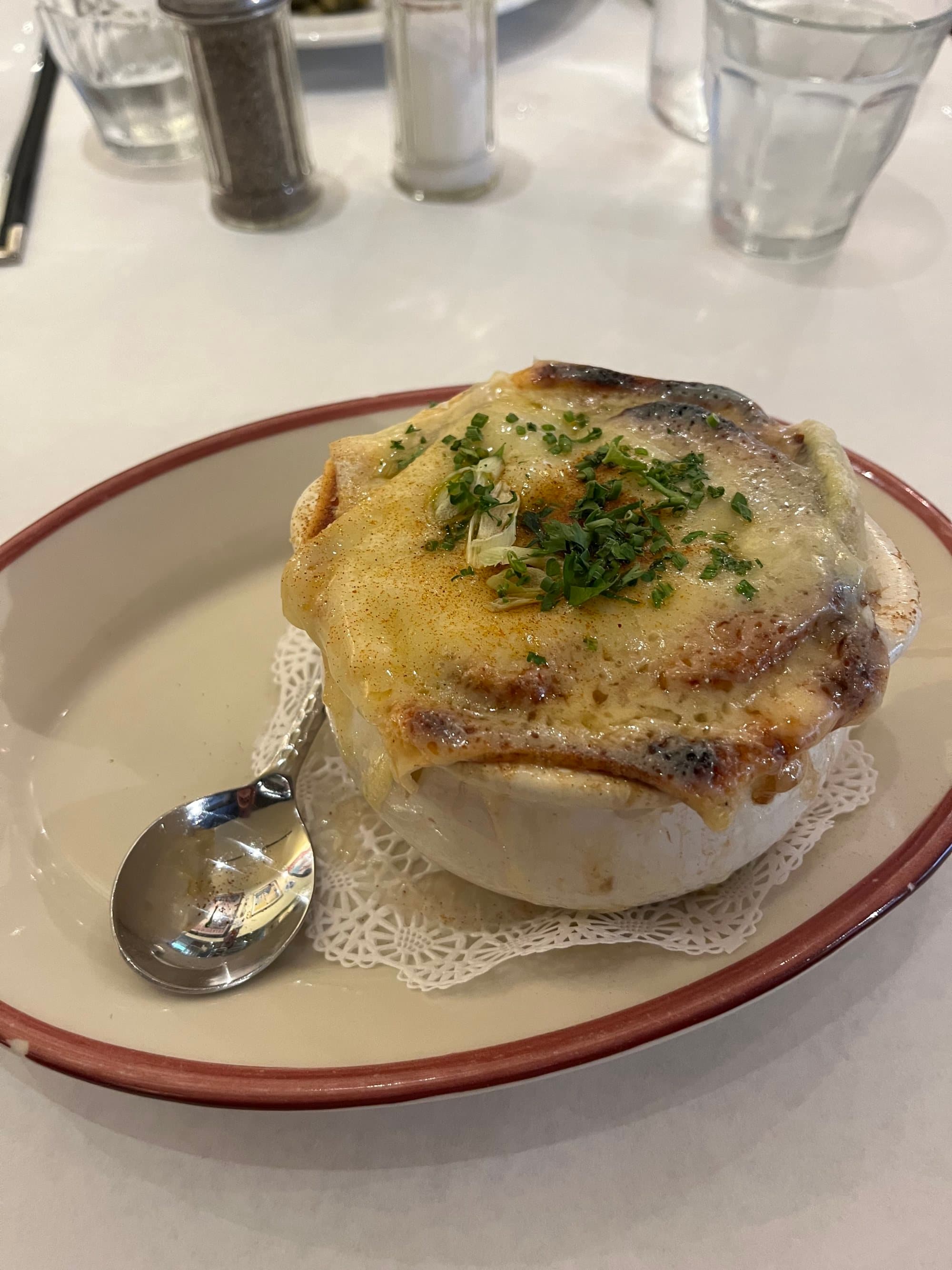 A souffle in a white ramekin sitting on a white plate on a table