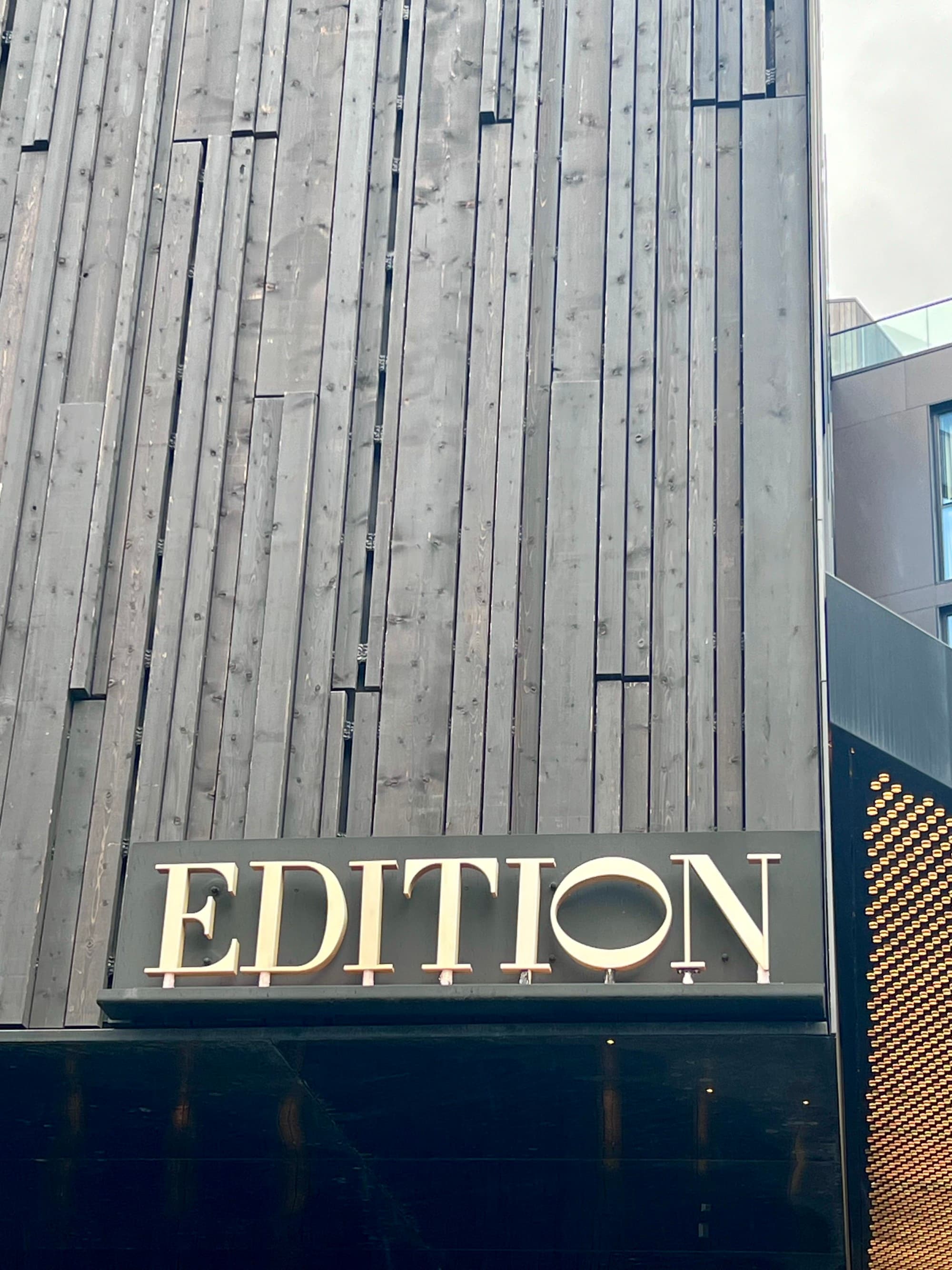 A view of hotel signage against the grey exterior