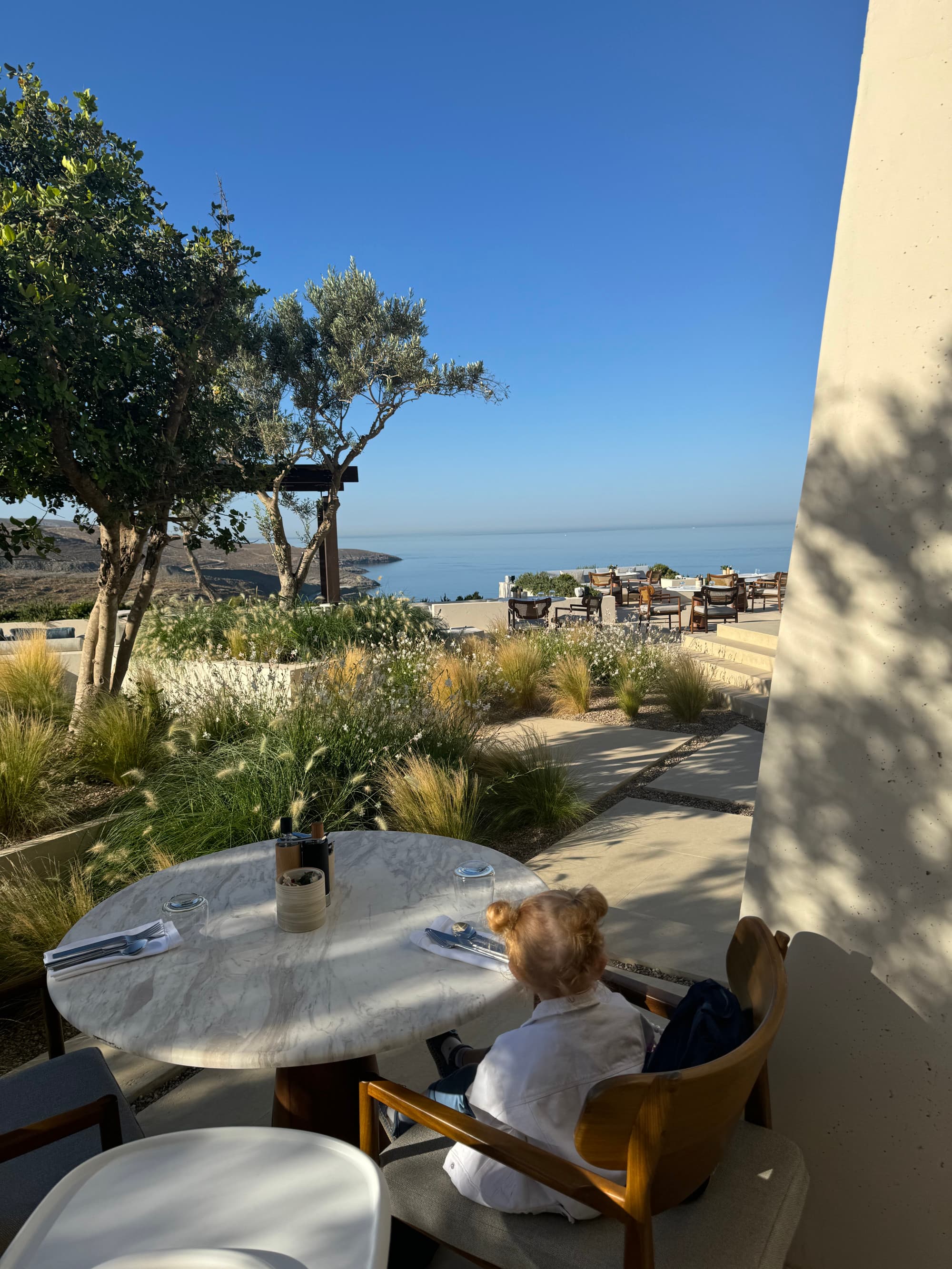 An outdoor coffee table on a patio overlooking the ocean.