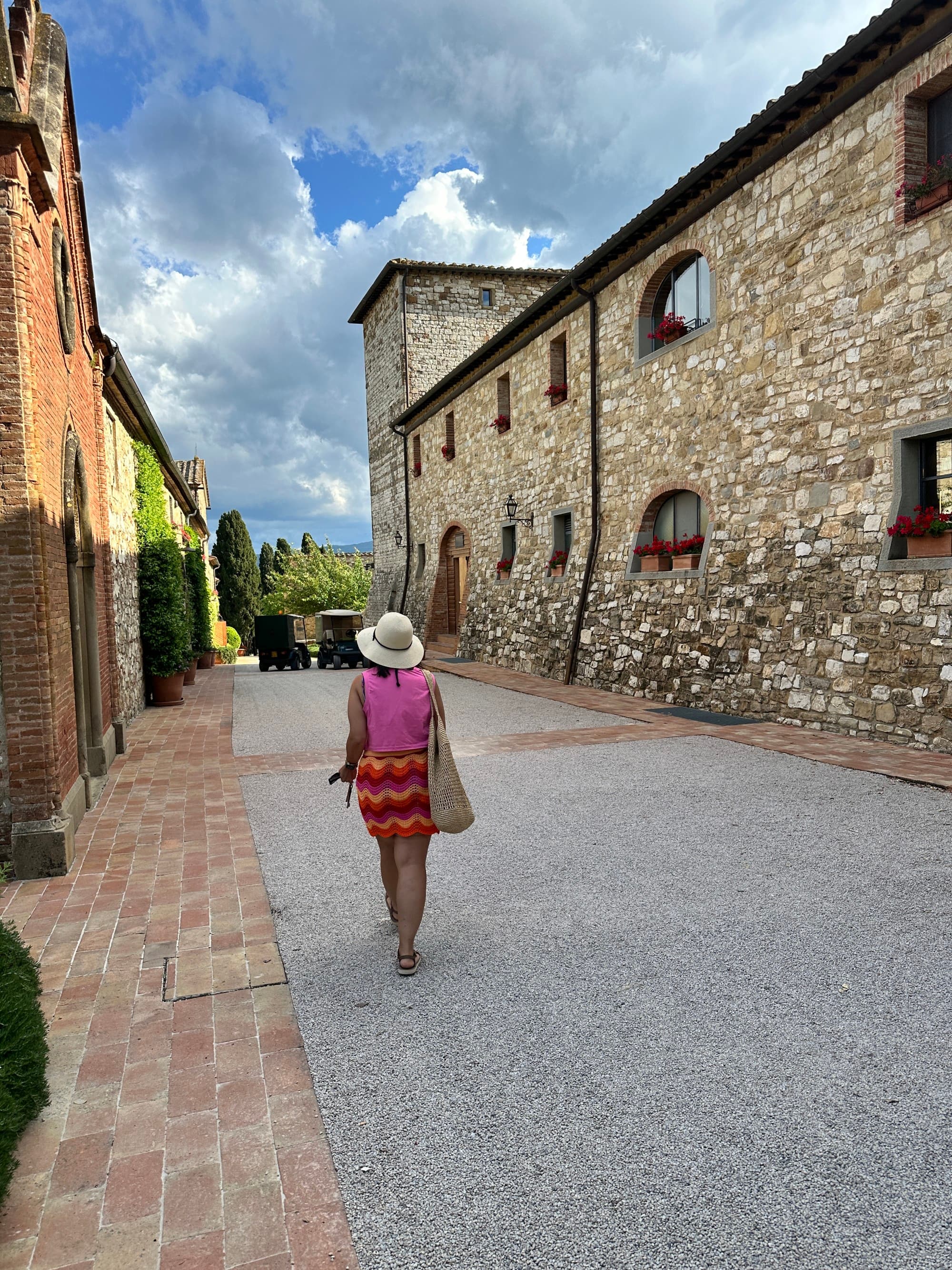 Advisor walking along hotel property on a cloudy day.