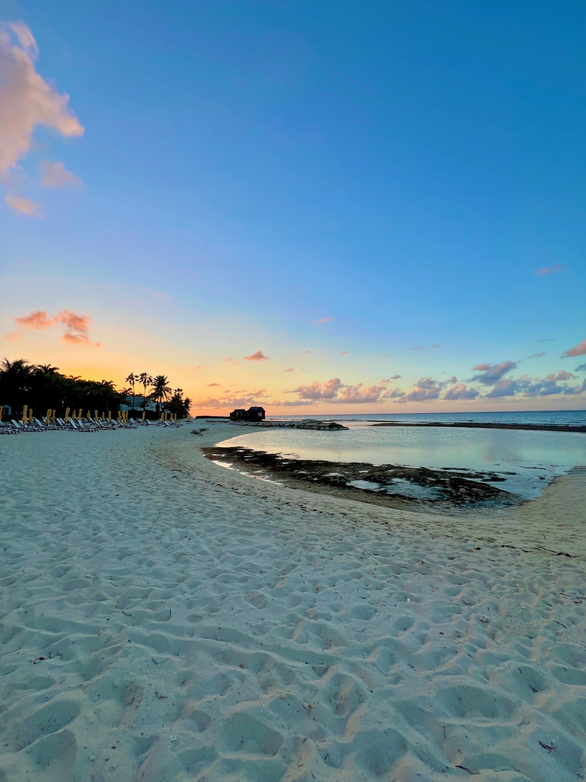 Sea and sand with blue sky behind.