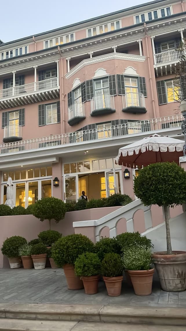 Exterior of pink hotel.