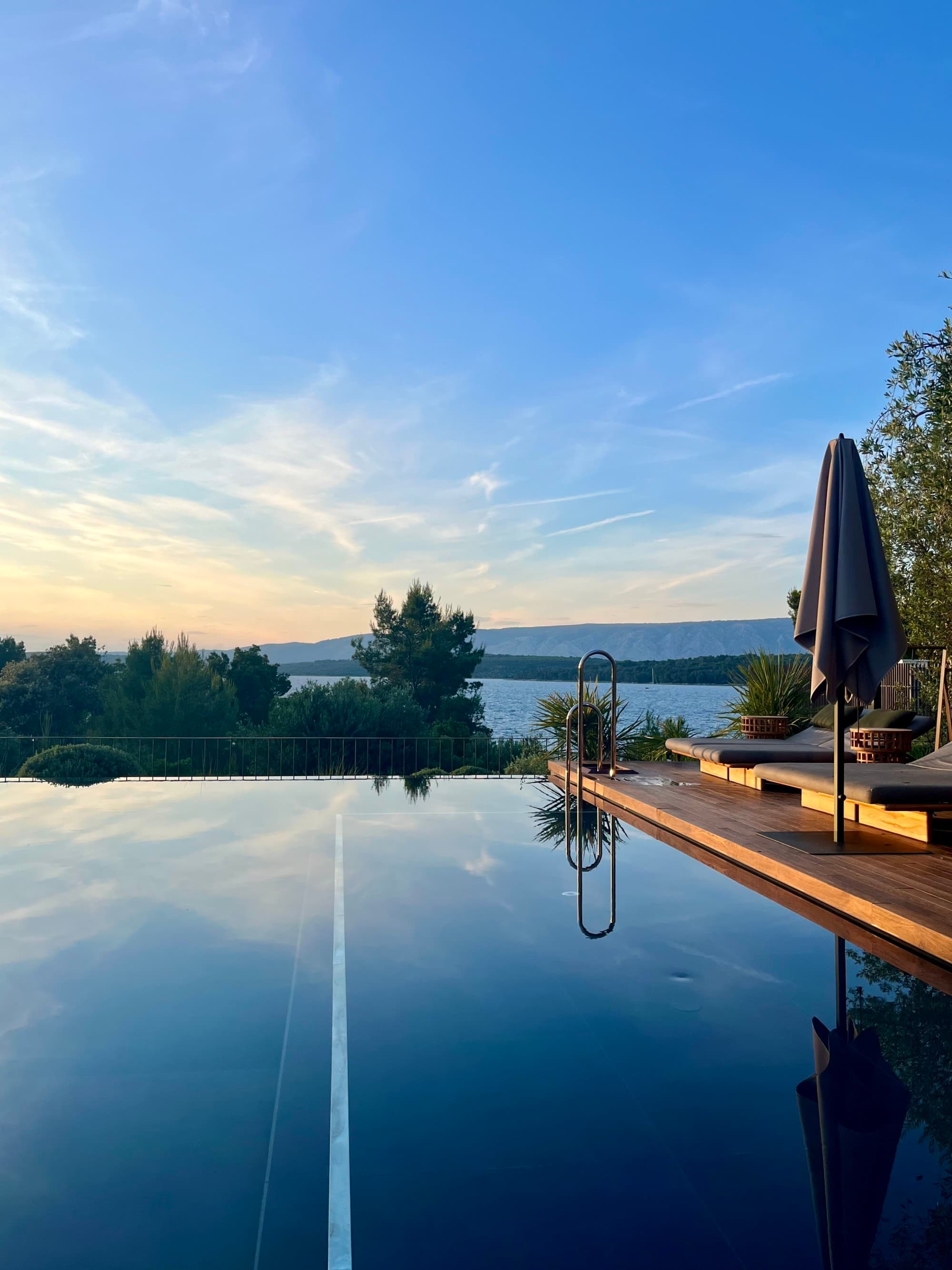 Sun sets over an infinity pool.