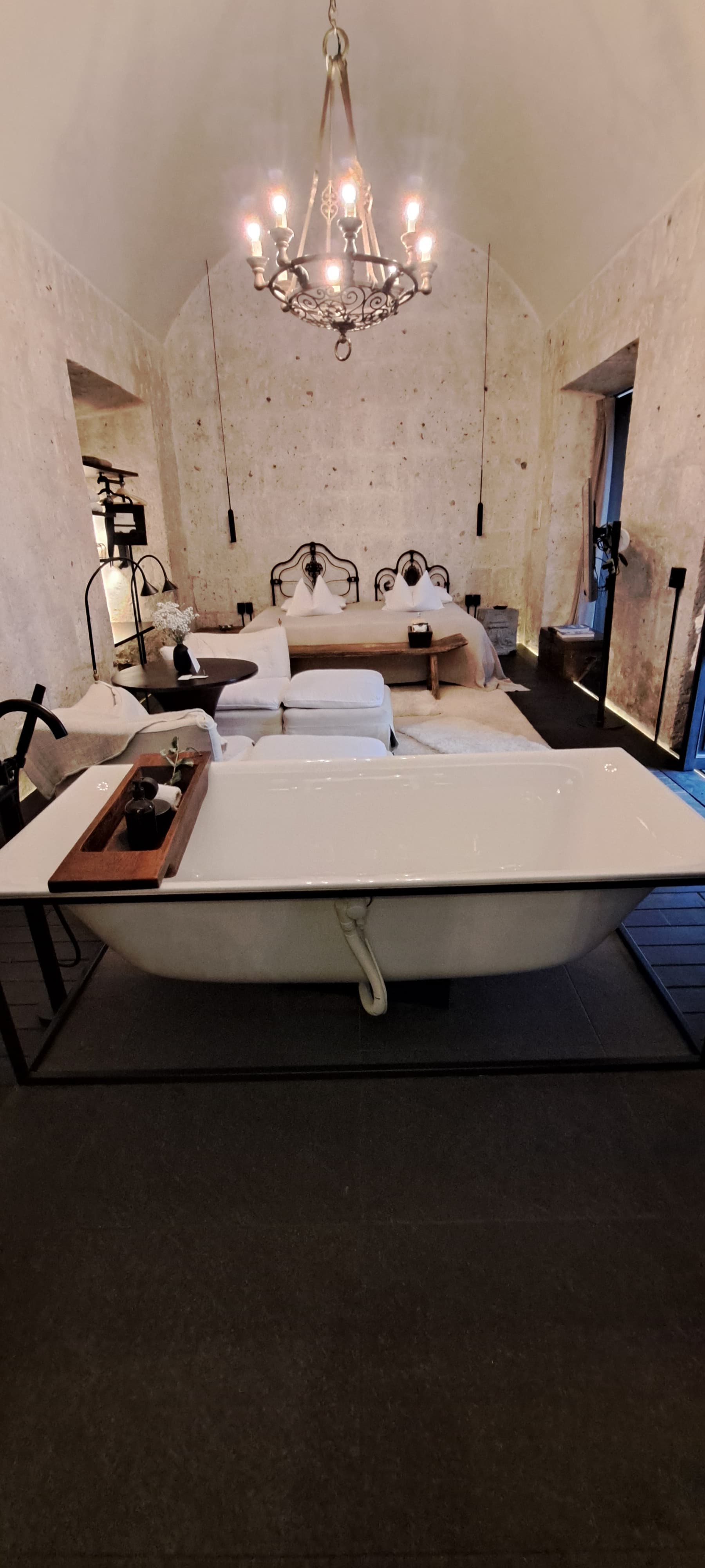 A luxurious hotel room with a stand-alone bathtub.