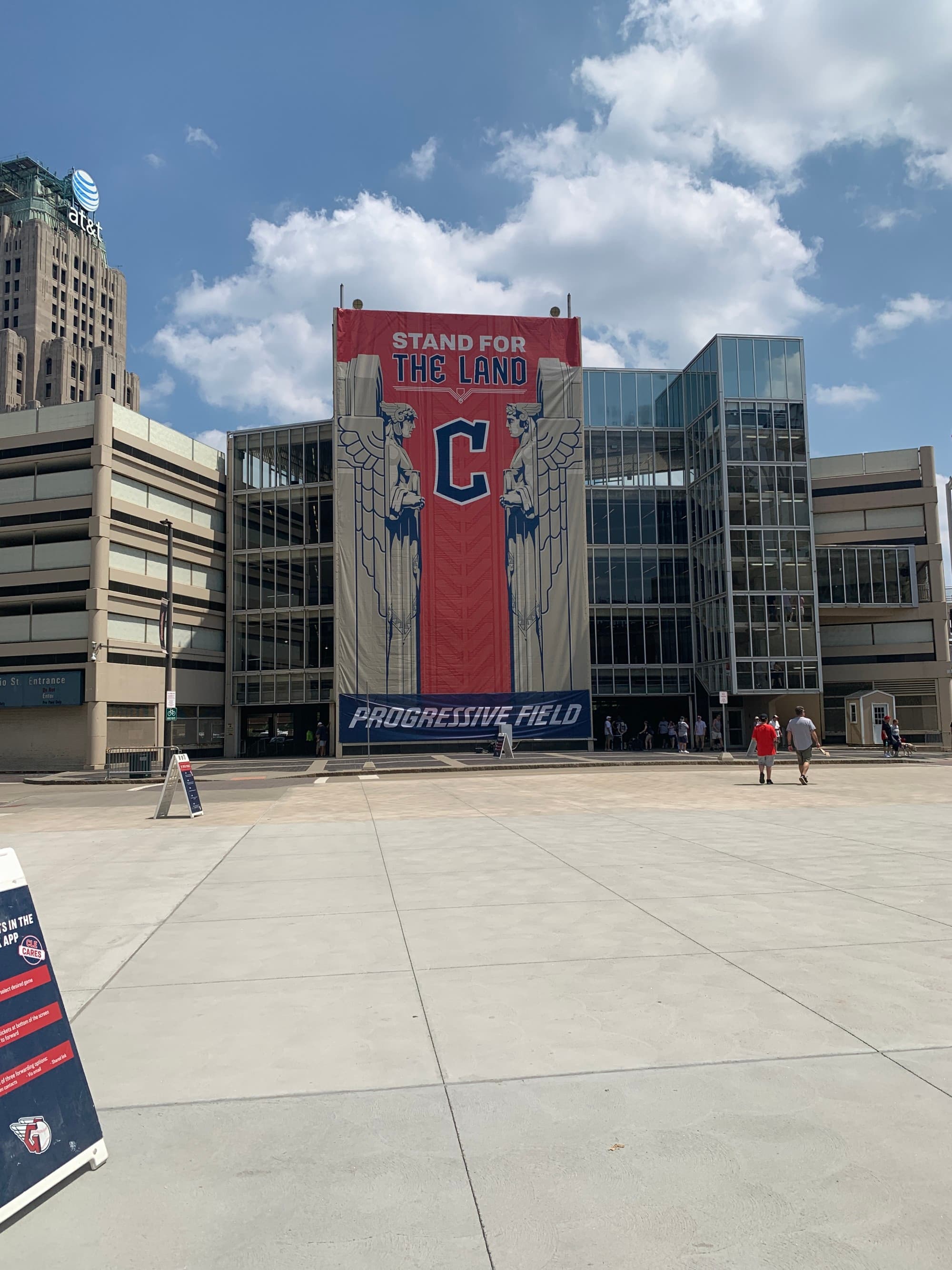 Plaza with a parking structure with a Cleveland Guardians logo.