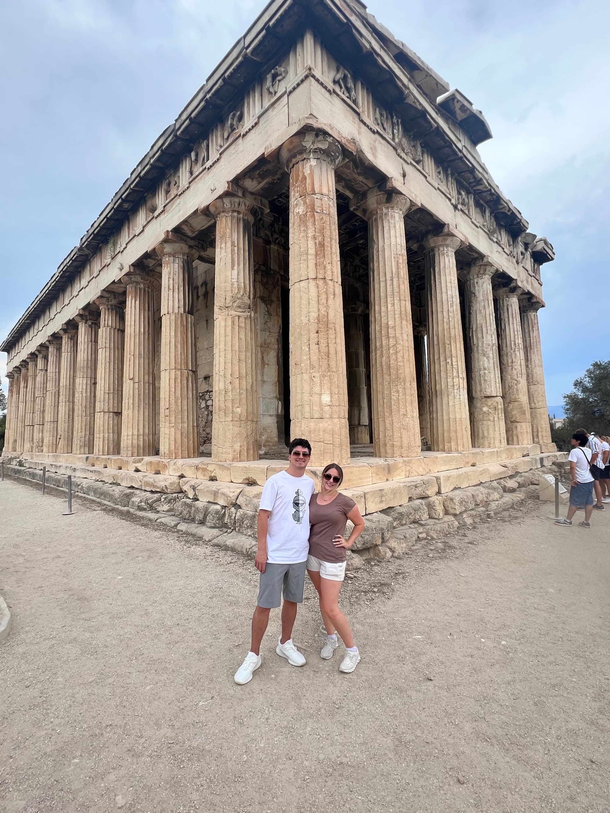 Couple poses together in front of a temple.
