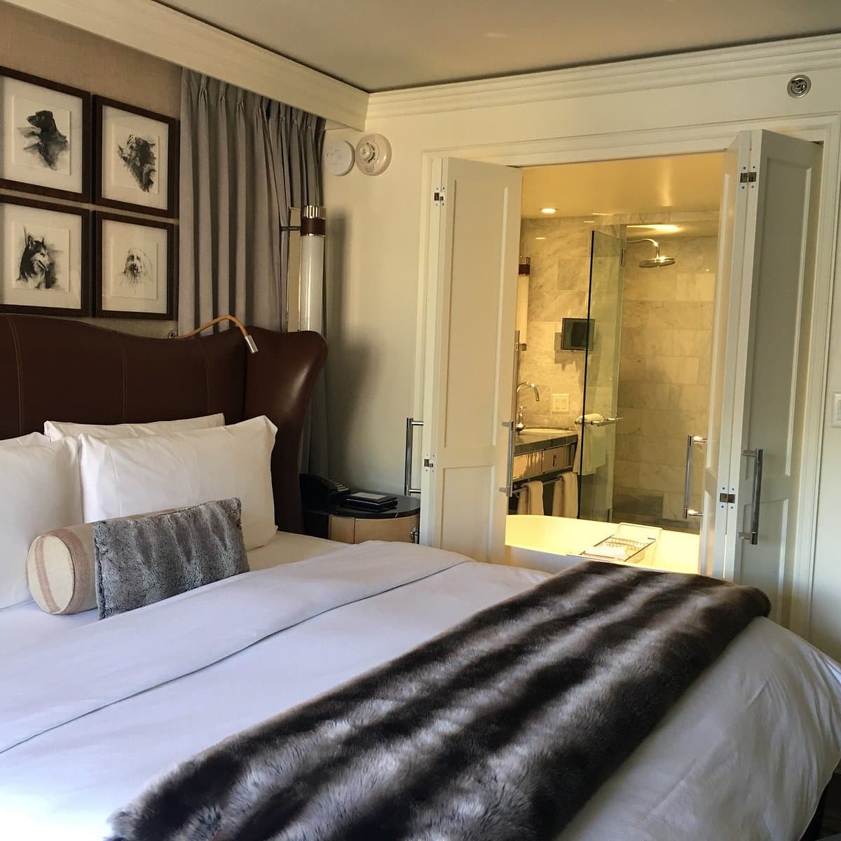 St. Regis Hotel bedroom features a cozy bed and modern bathroom amenities.