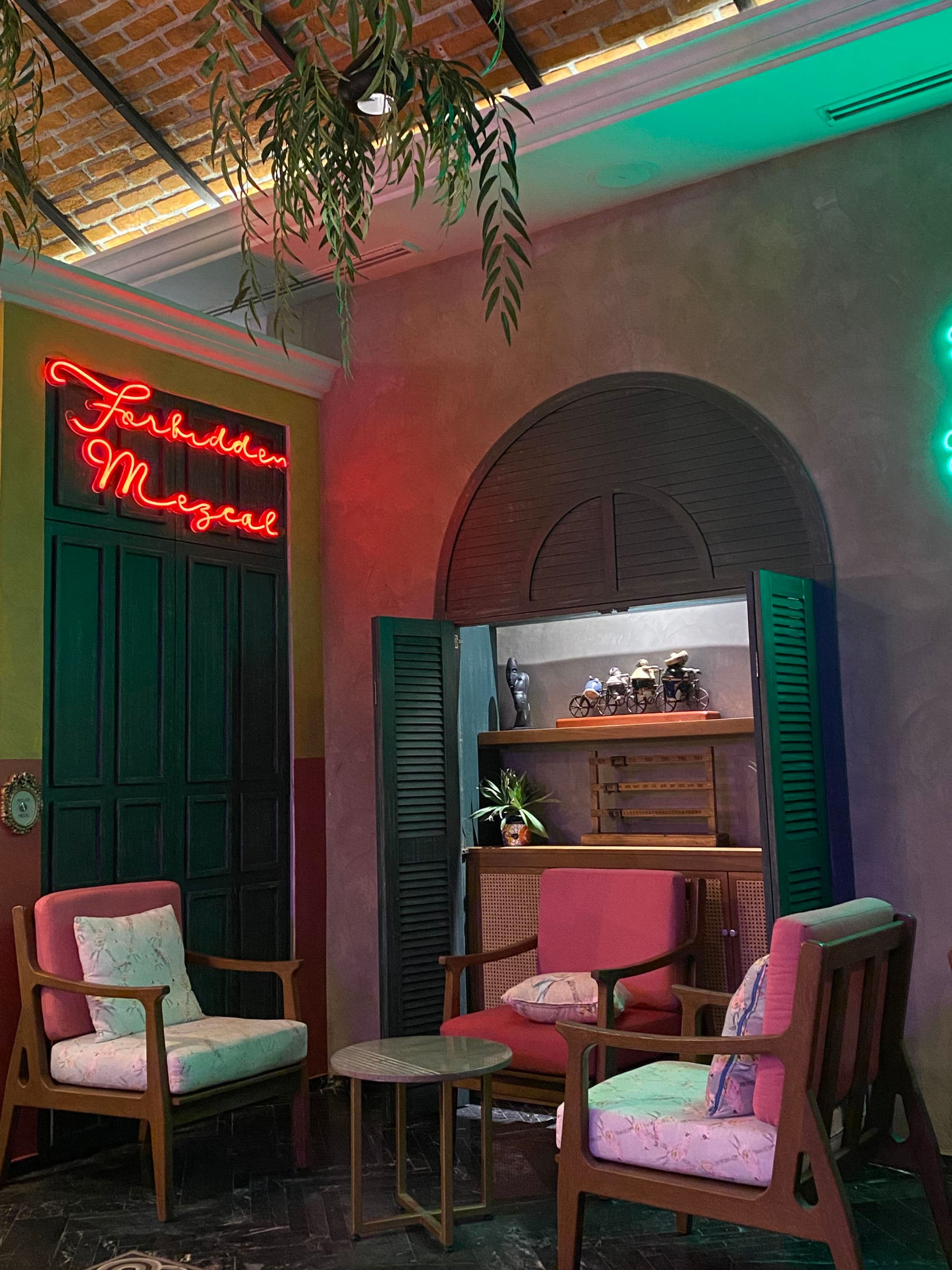 A dark-lit seating area with a neon sign above
