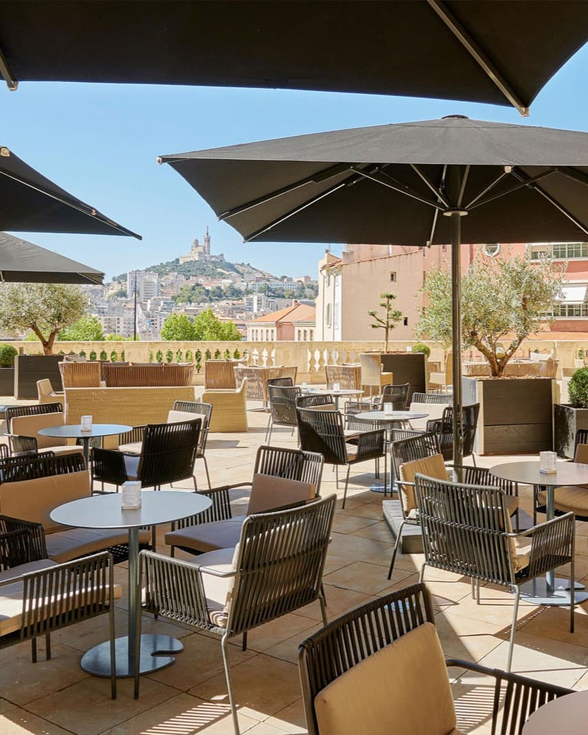 An outside patio area with tables and chairs for dining