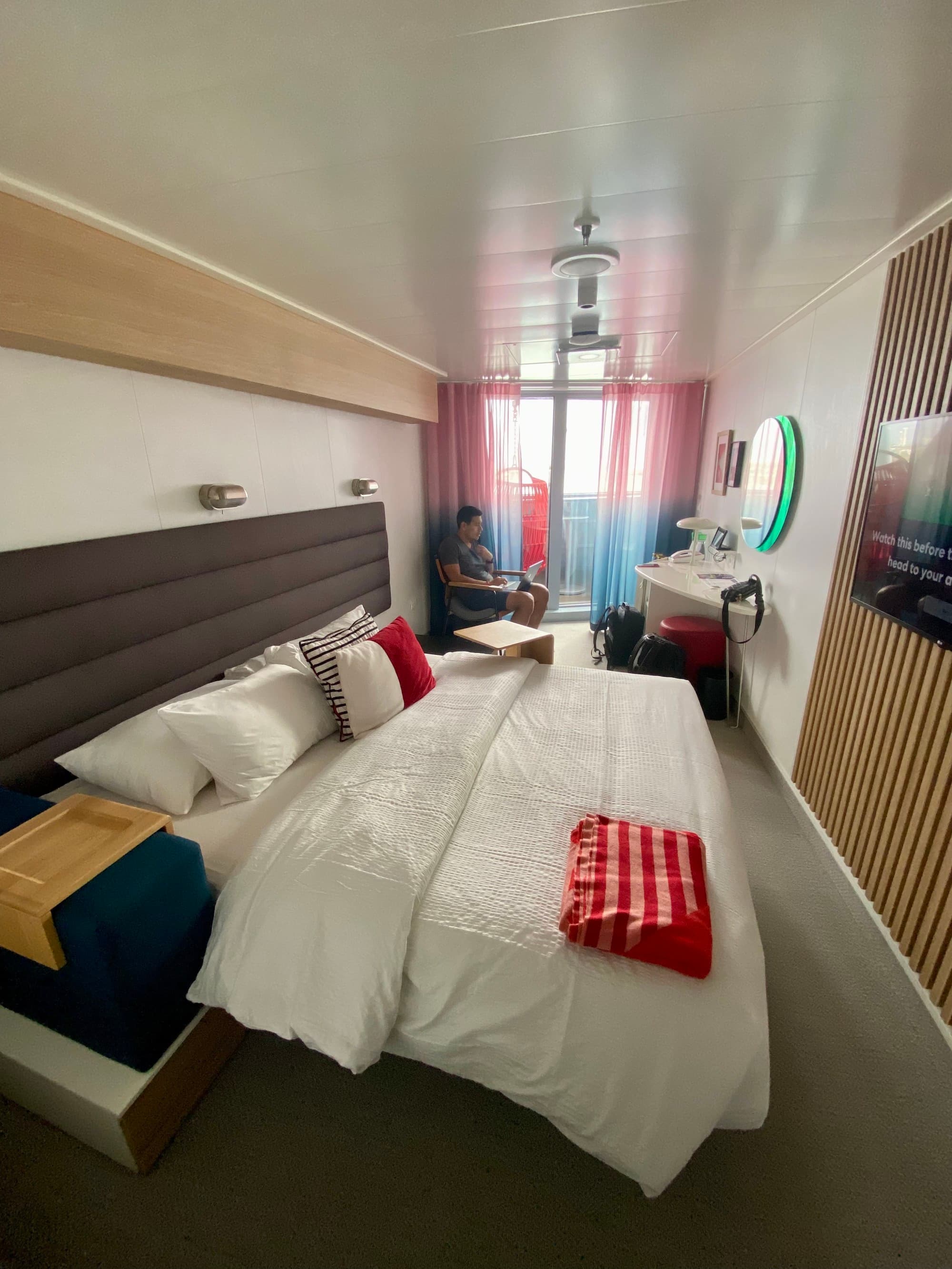 A hotel room suite on a cruise ship with a better in the center