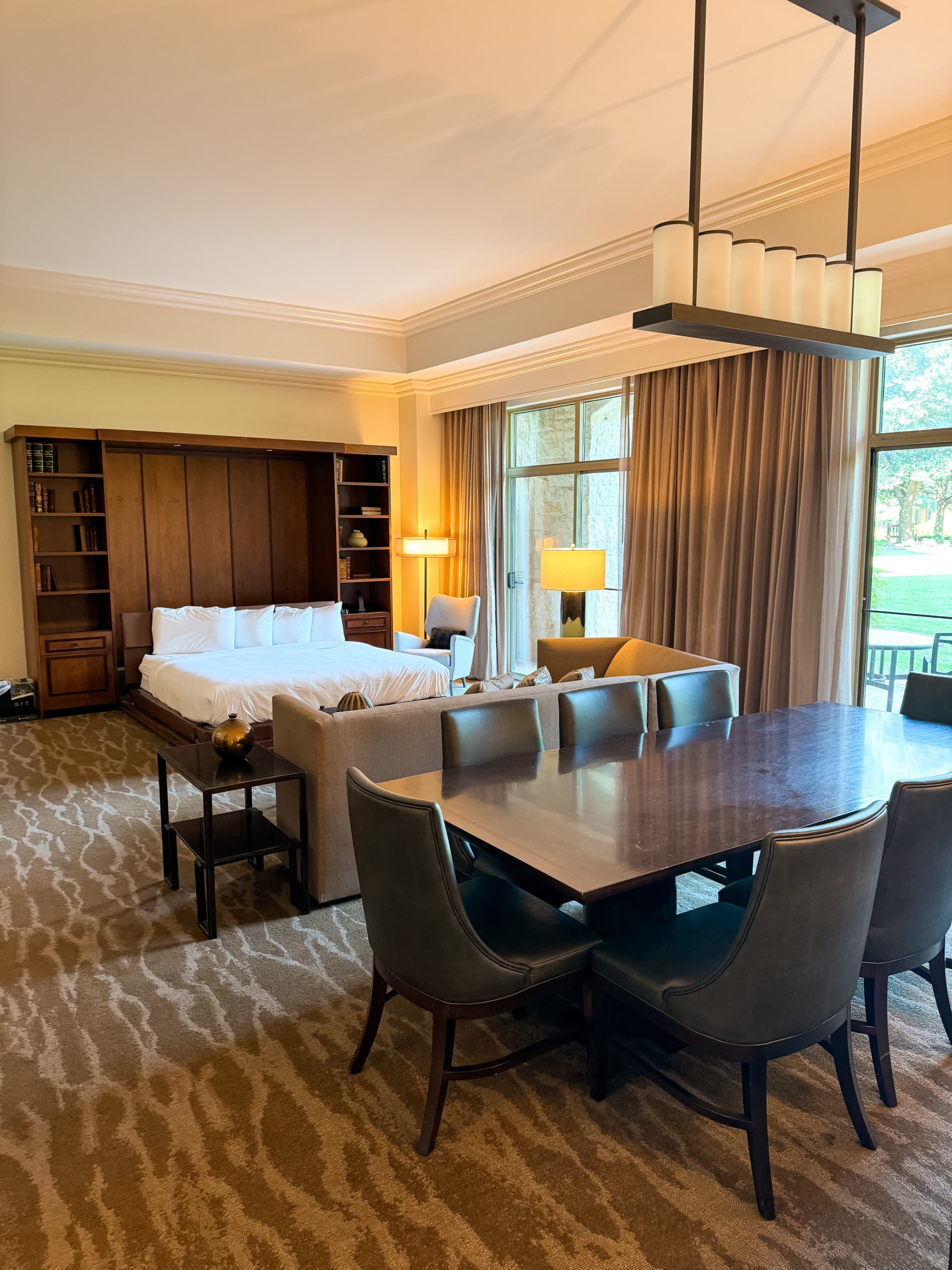 A suite features a dining area separate from the bedroom with full light streaming through the windows.