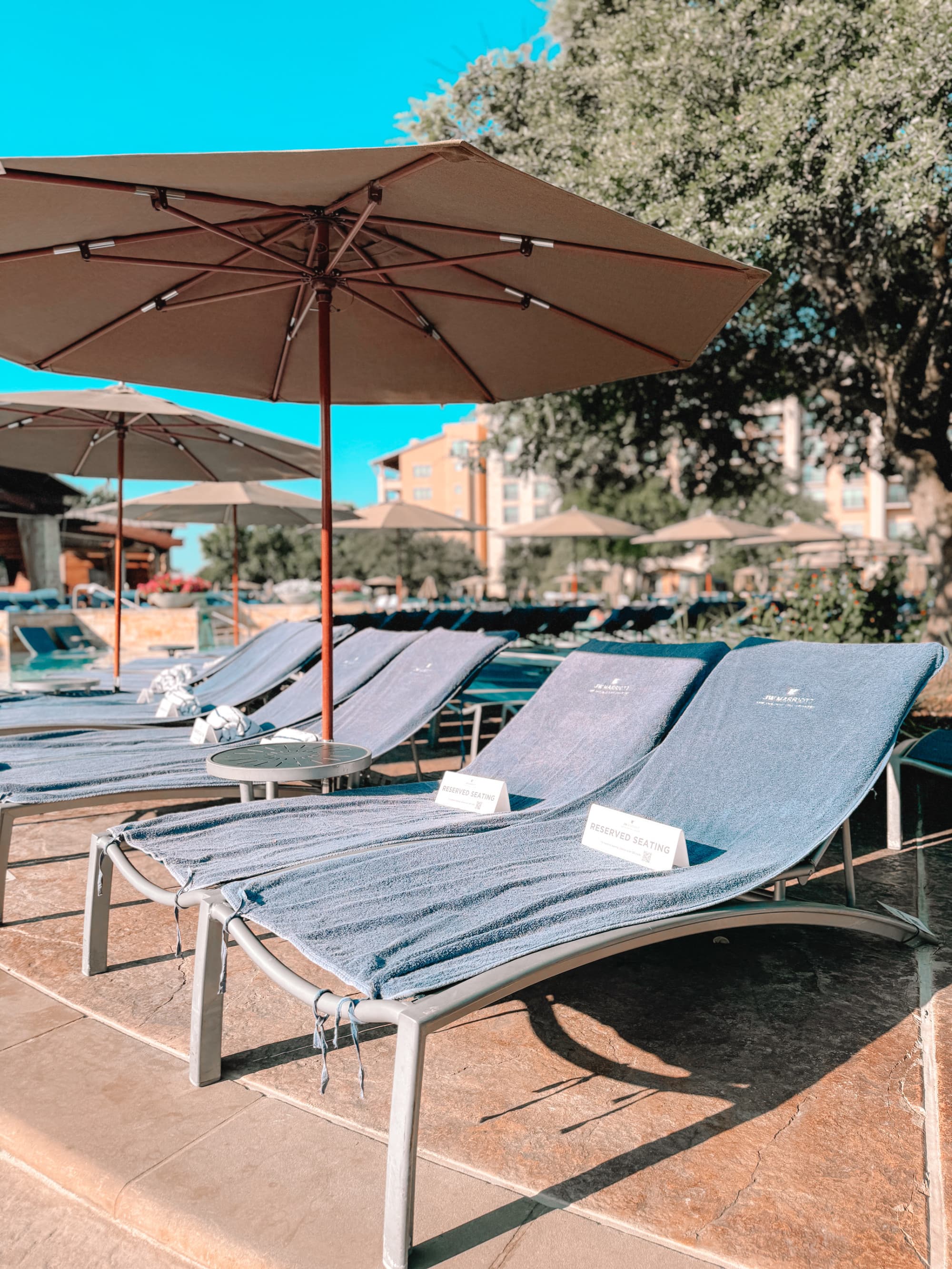 Reserved pool seating is available under expansive umbrellas.