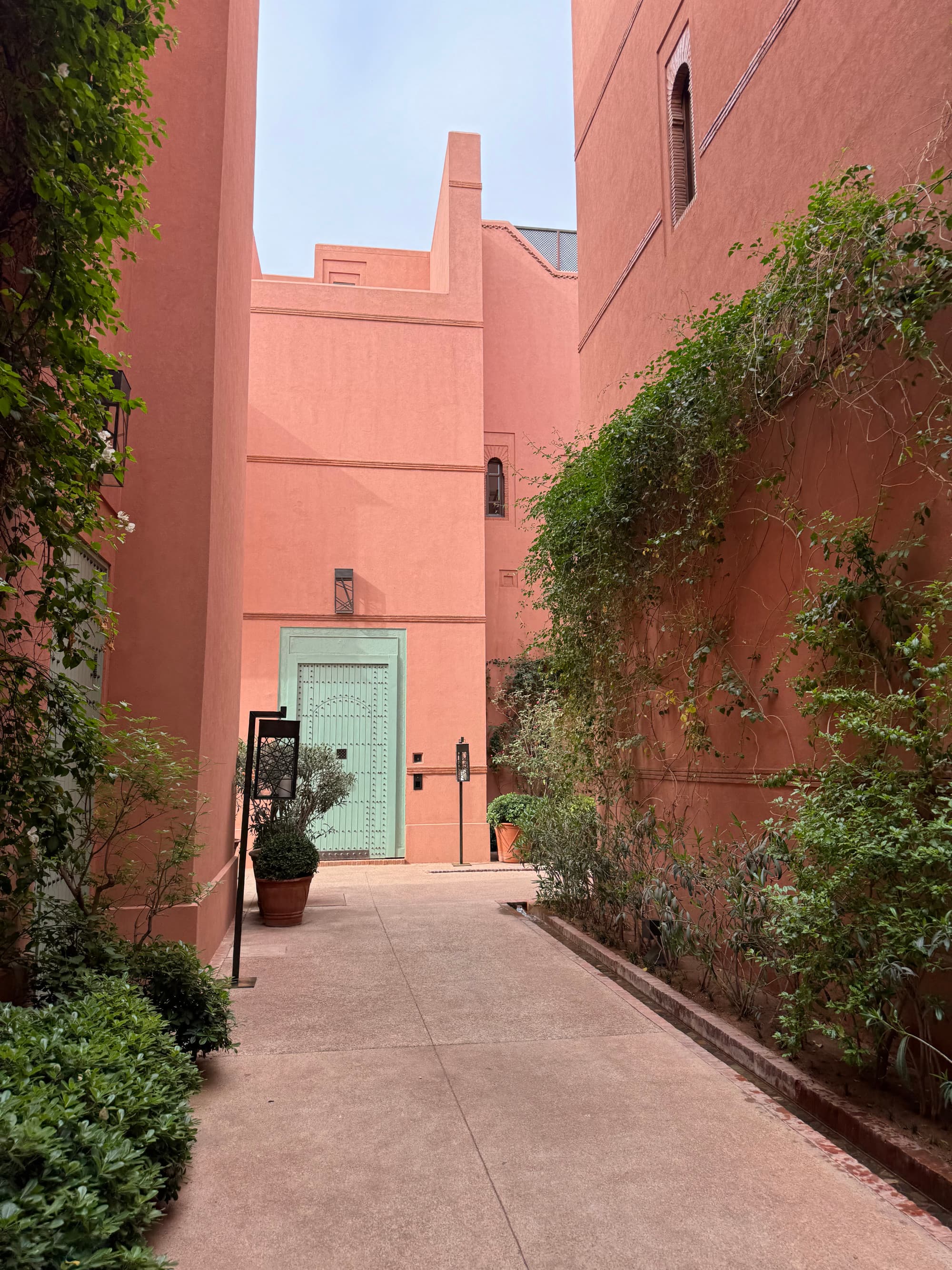 An alleyway between two coral-colored buildings