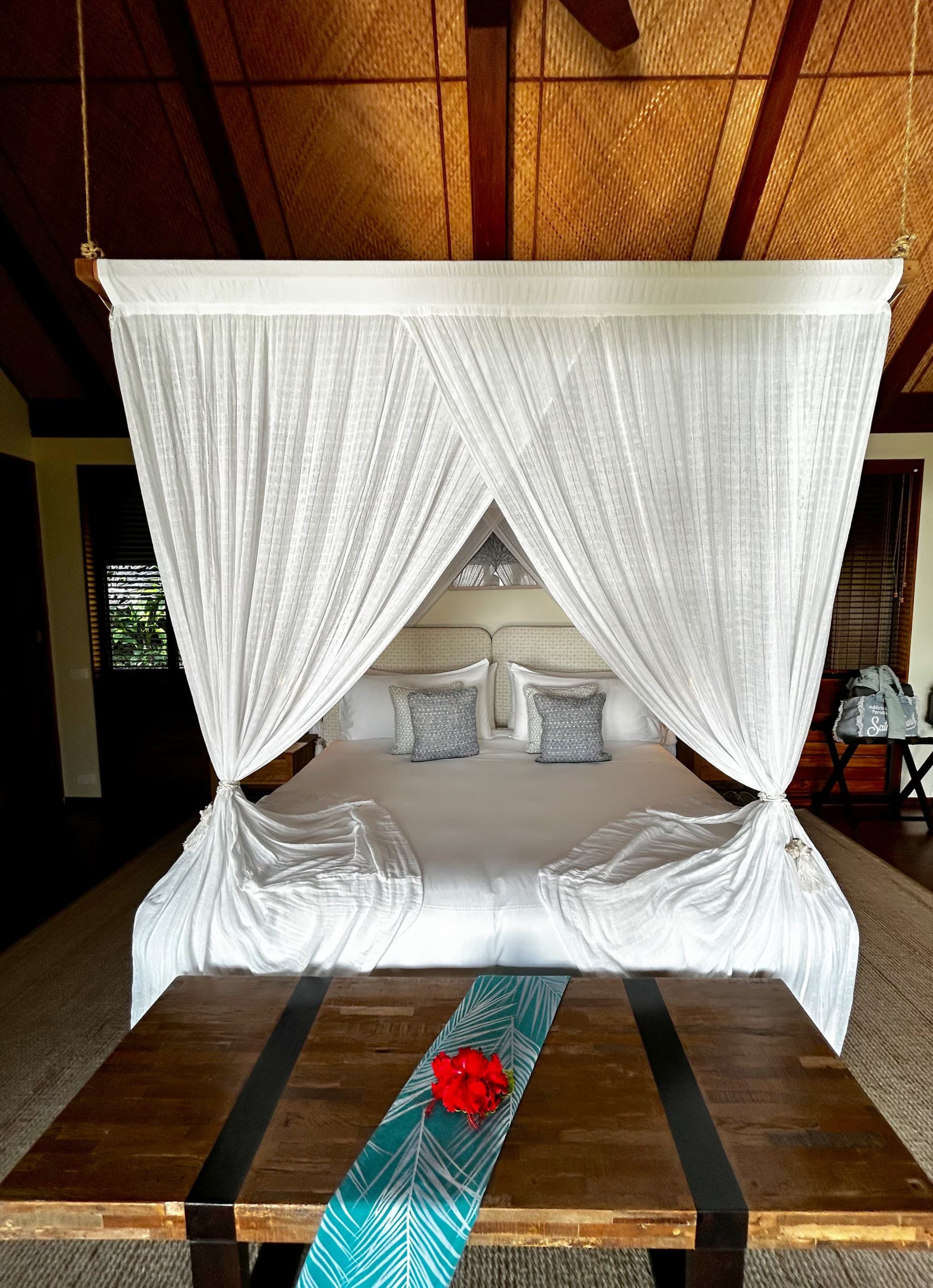 A draped bed in a hotel room suite