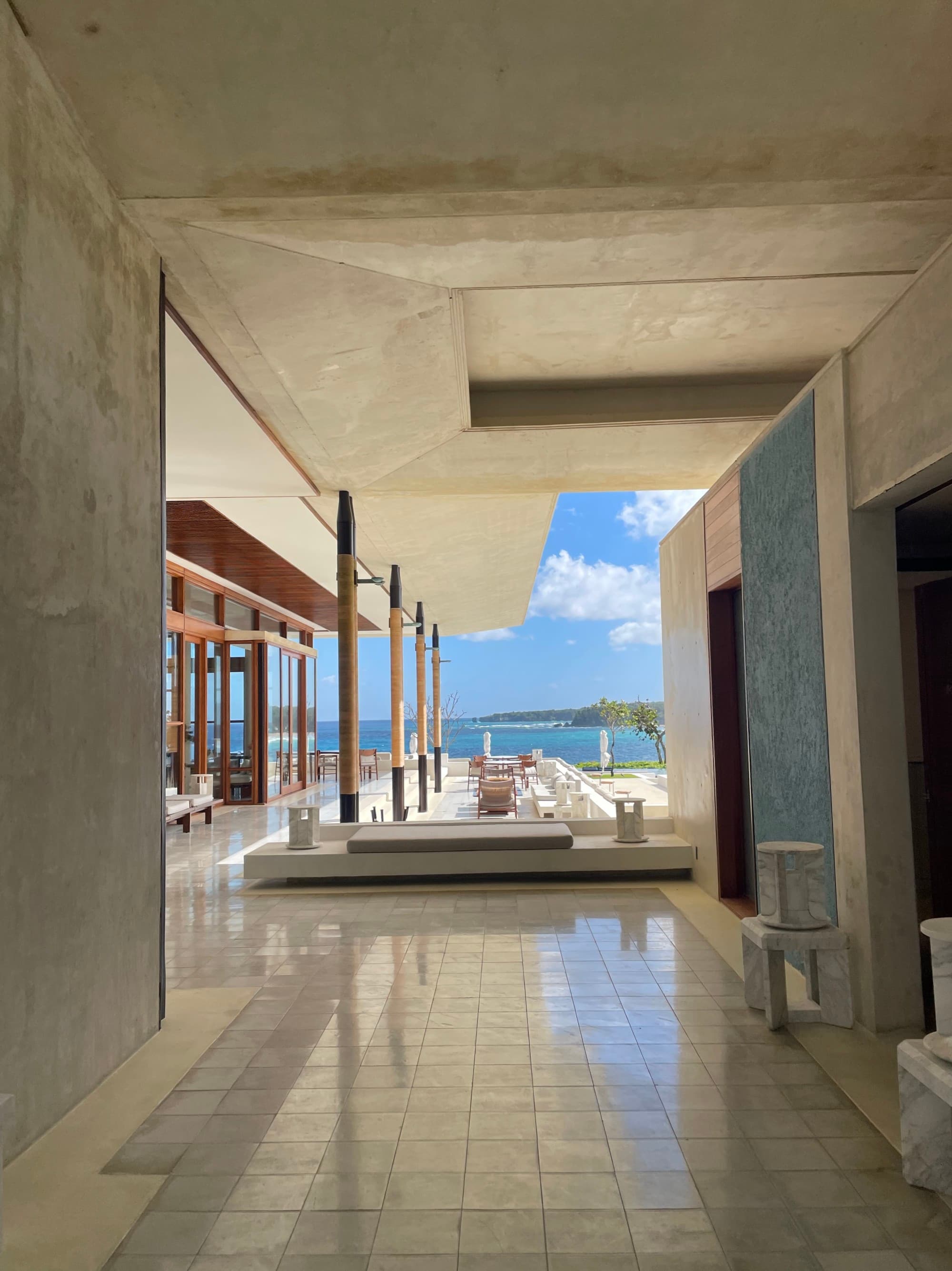 An open-air hotel lobby with marble floors.