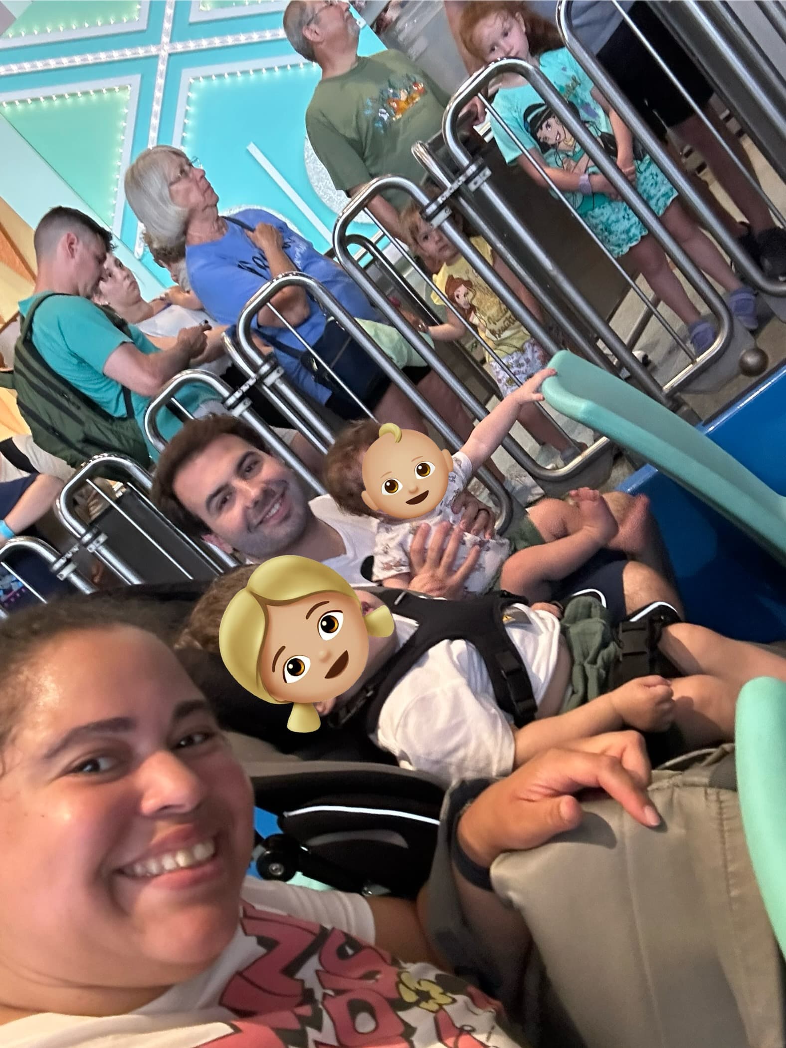 A family poses before embarking on a Disney ride.