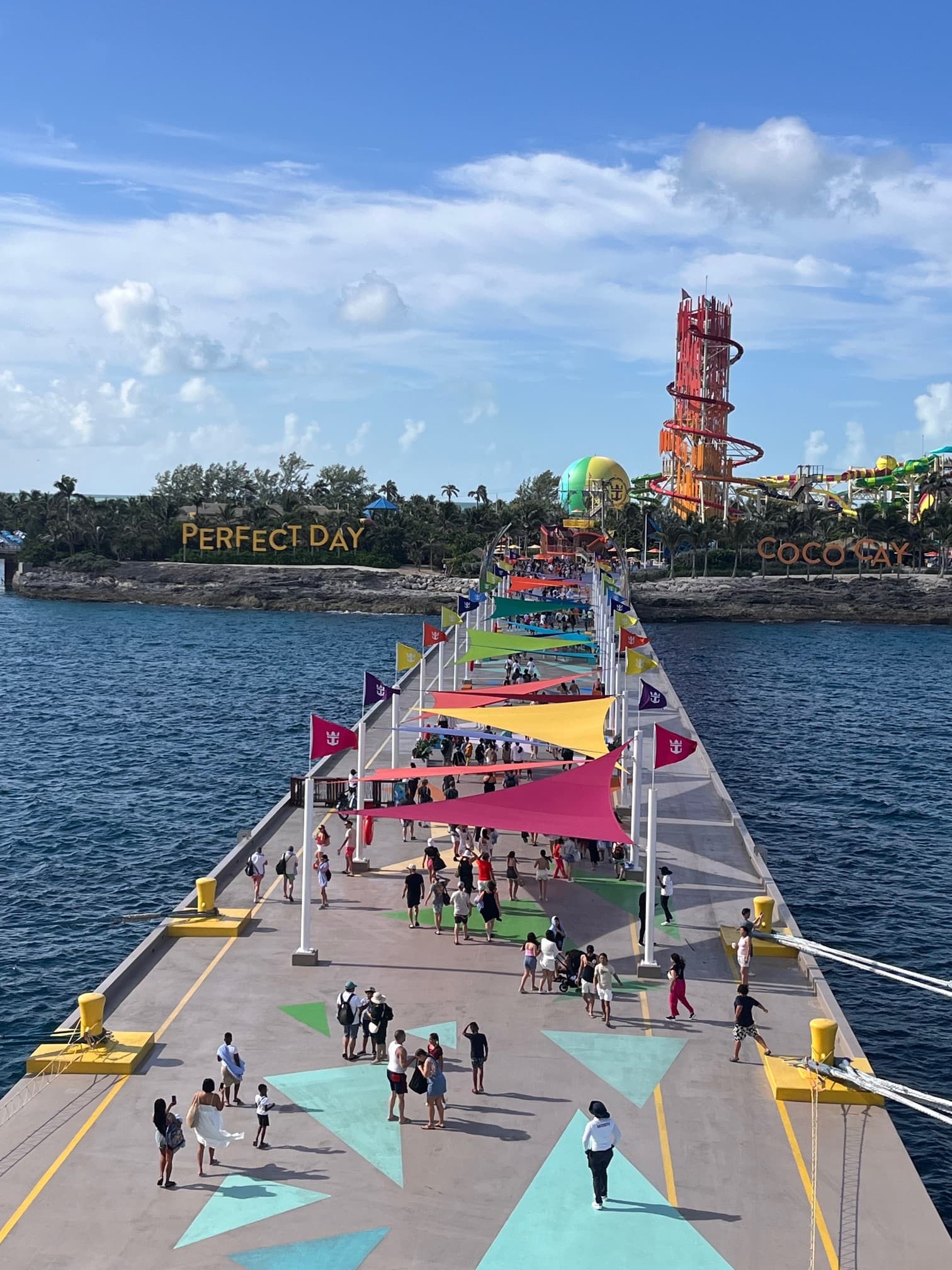 A boardwalk with colorful flags during the daytime