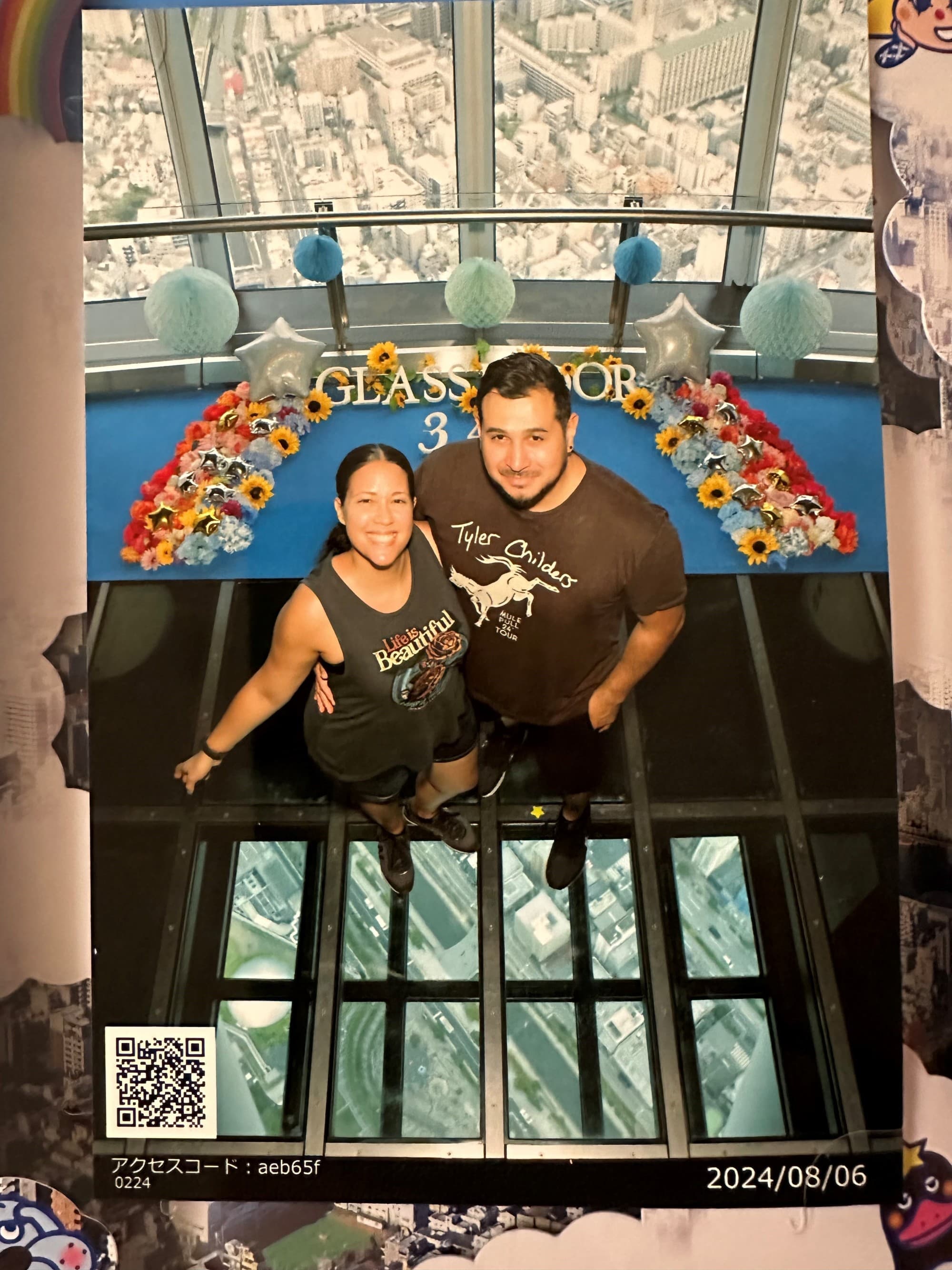 Two people standing on a glass platform showing a city underneath