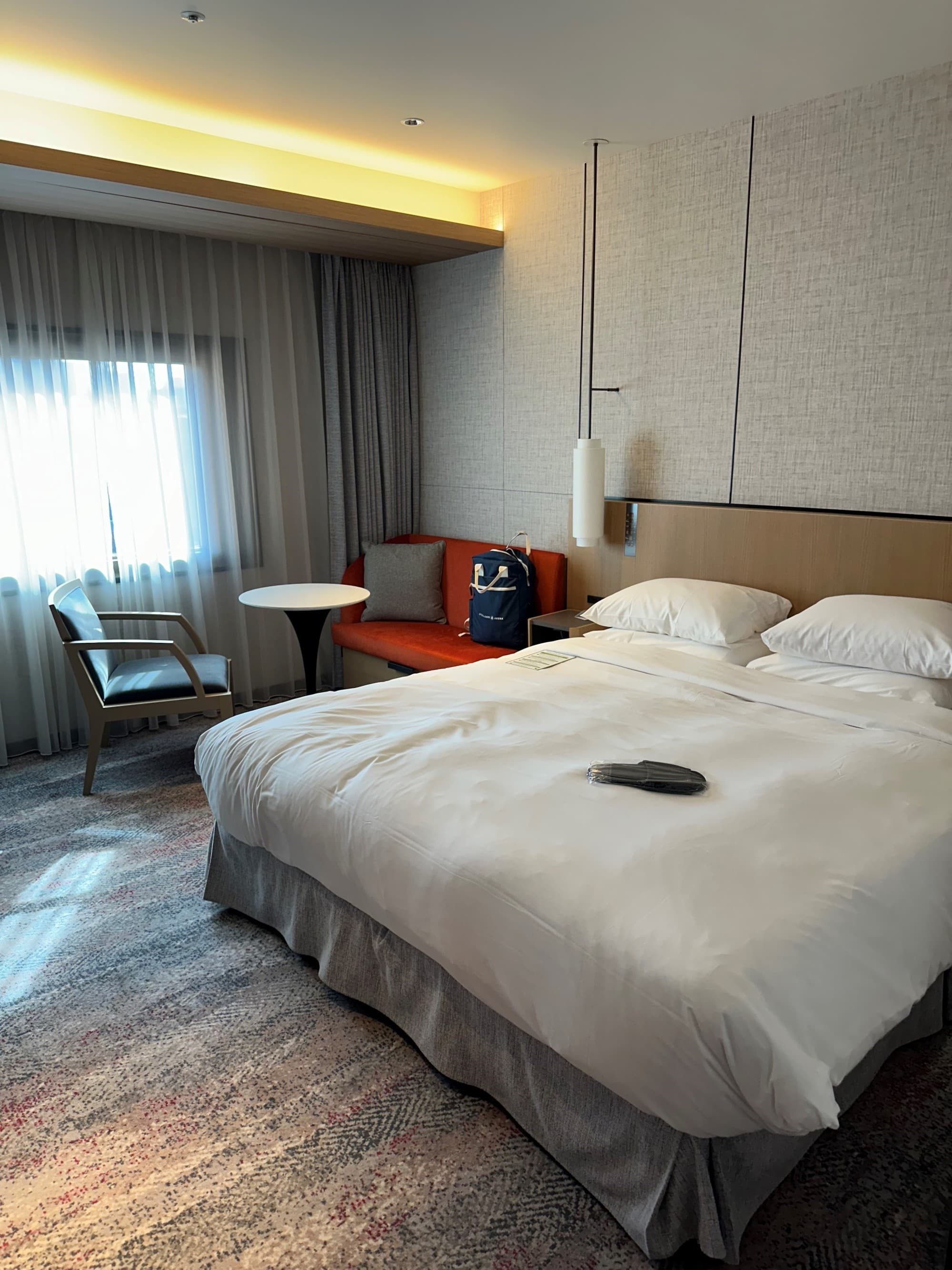 A bed in the middle of a hotel room